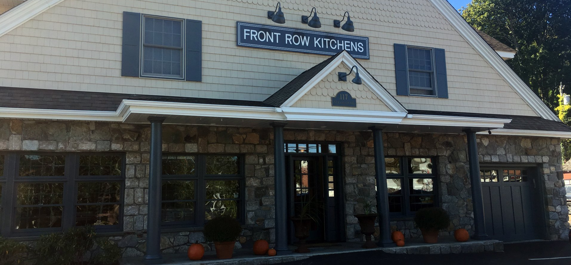 Exterior of a restaurant with a stone facade, sign reading