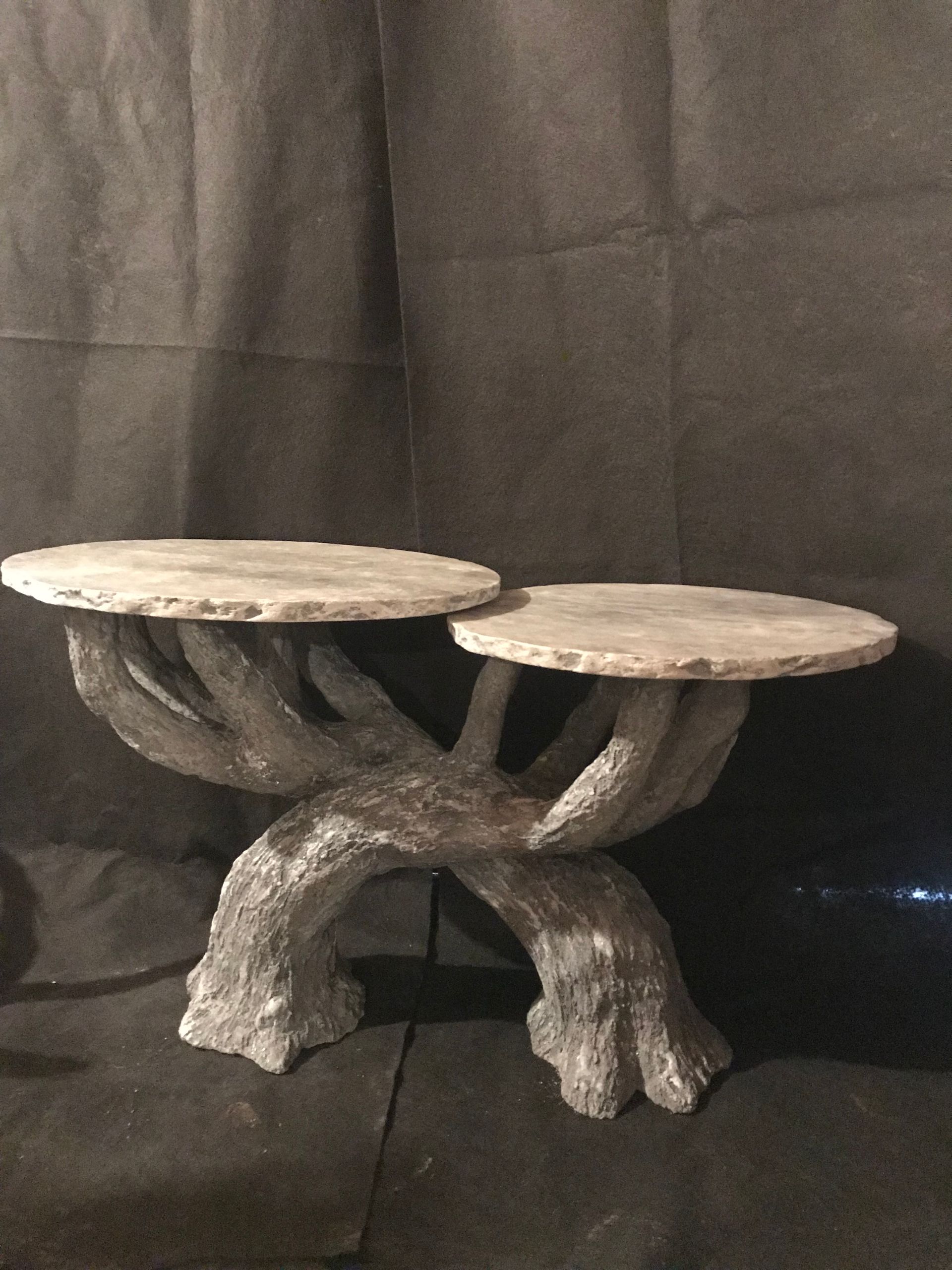 A tree trunk shaped table with two plates on it
