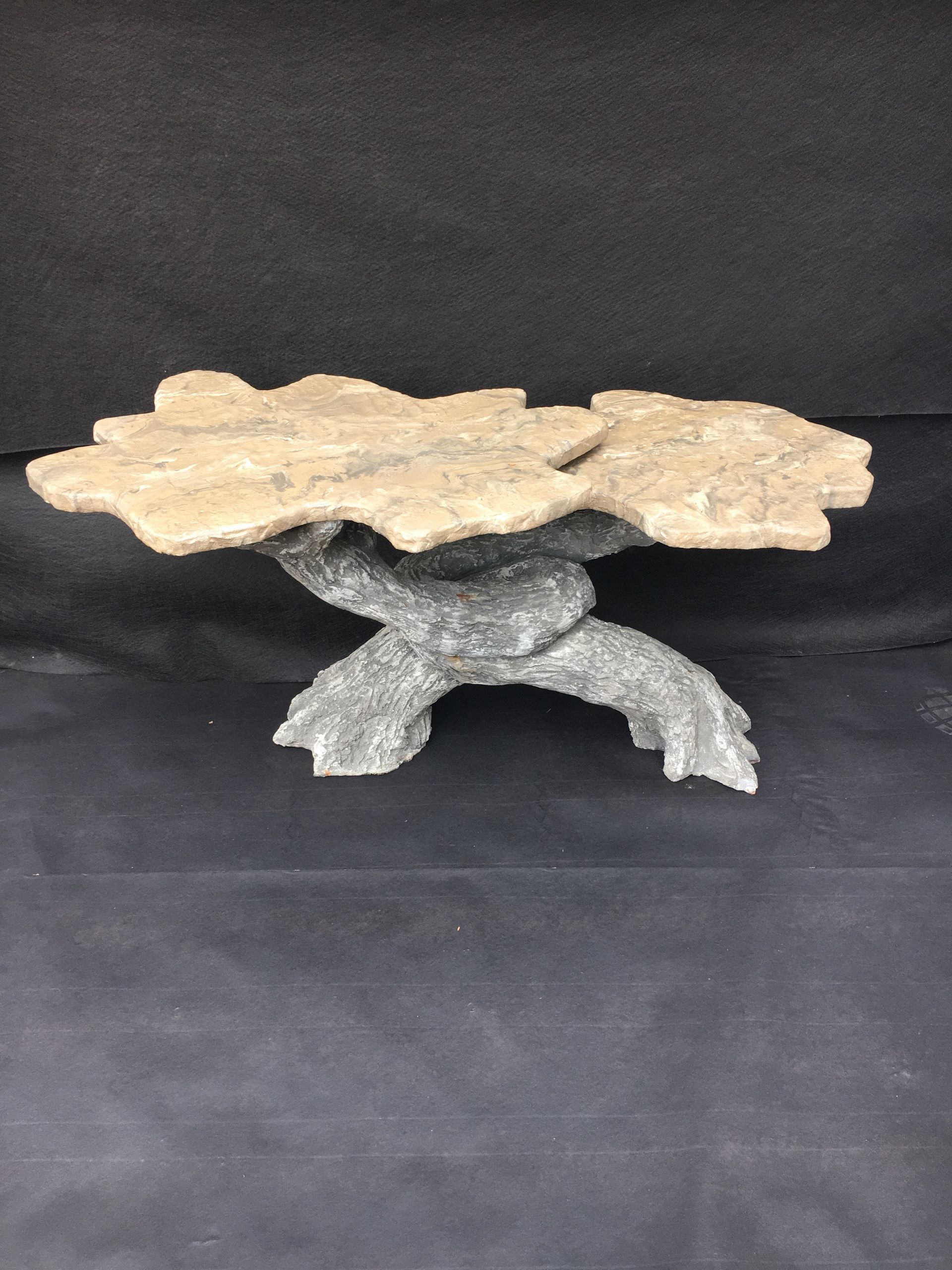 A table made of rocks is sitting on a black surface.