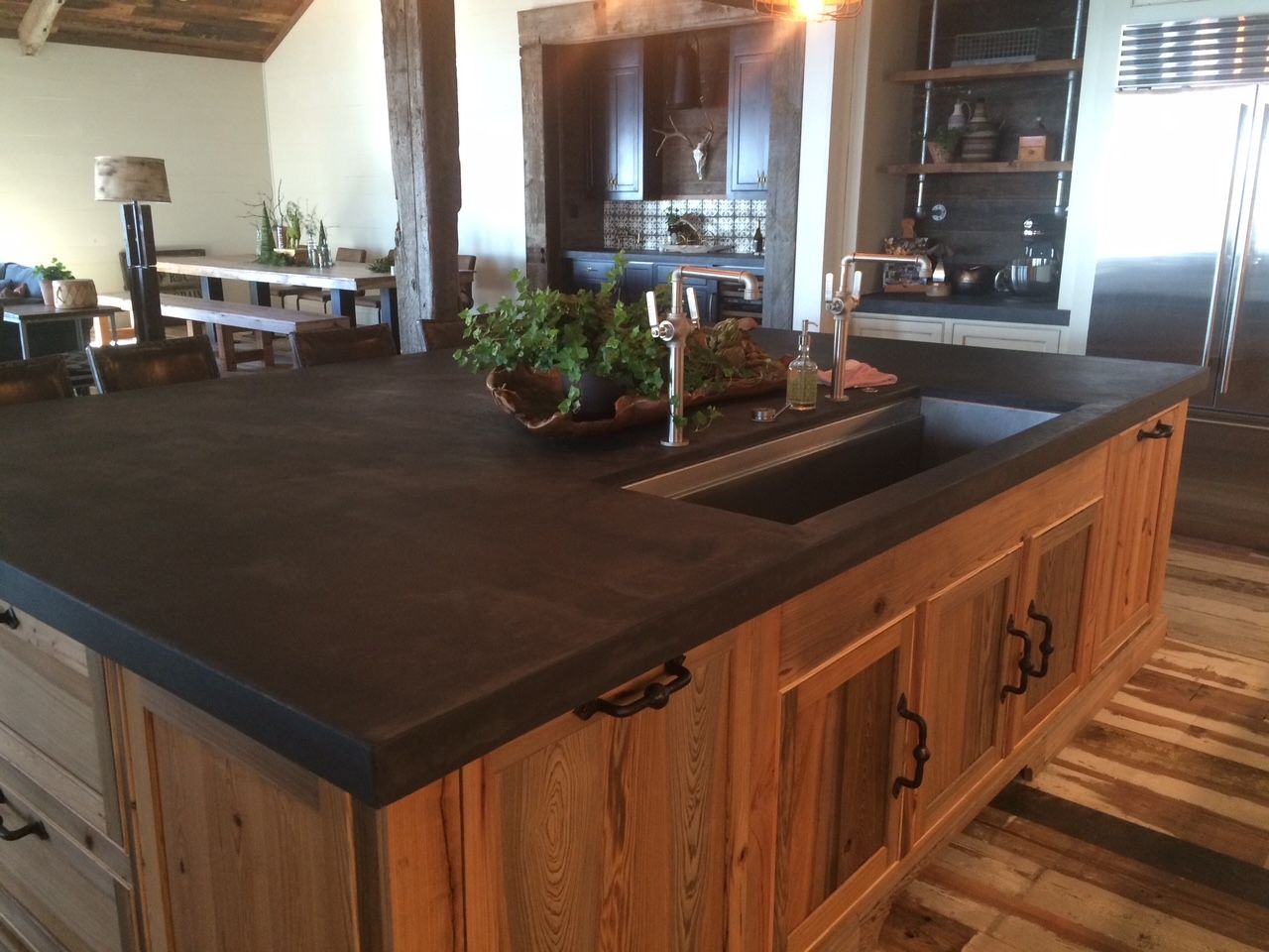 A kitchen with wooden cabinets and a black counter top