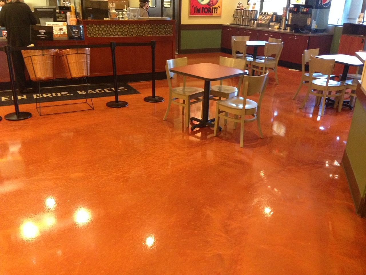 A restaurant with tables and chairs and a counter