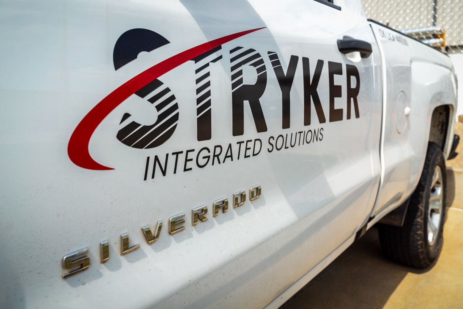 A silverado truck with stryker integrated solutions written on the side