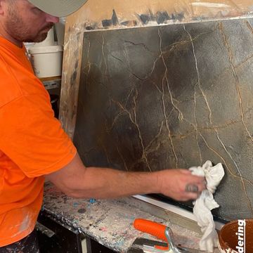 Man wiping textured cement — Renderers in Brisbane, QLD