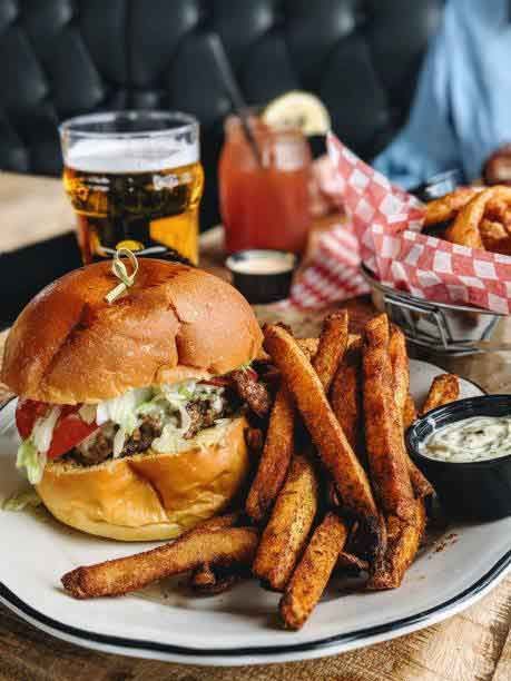 A plate of food with a hamburger and french fries on a table.