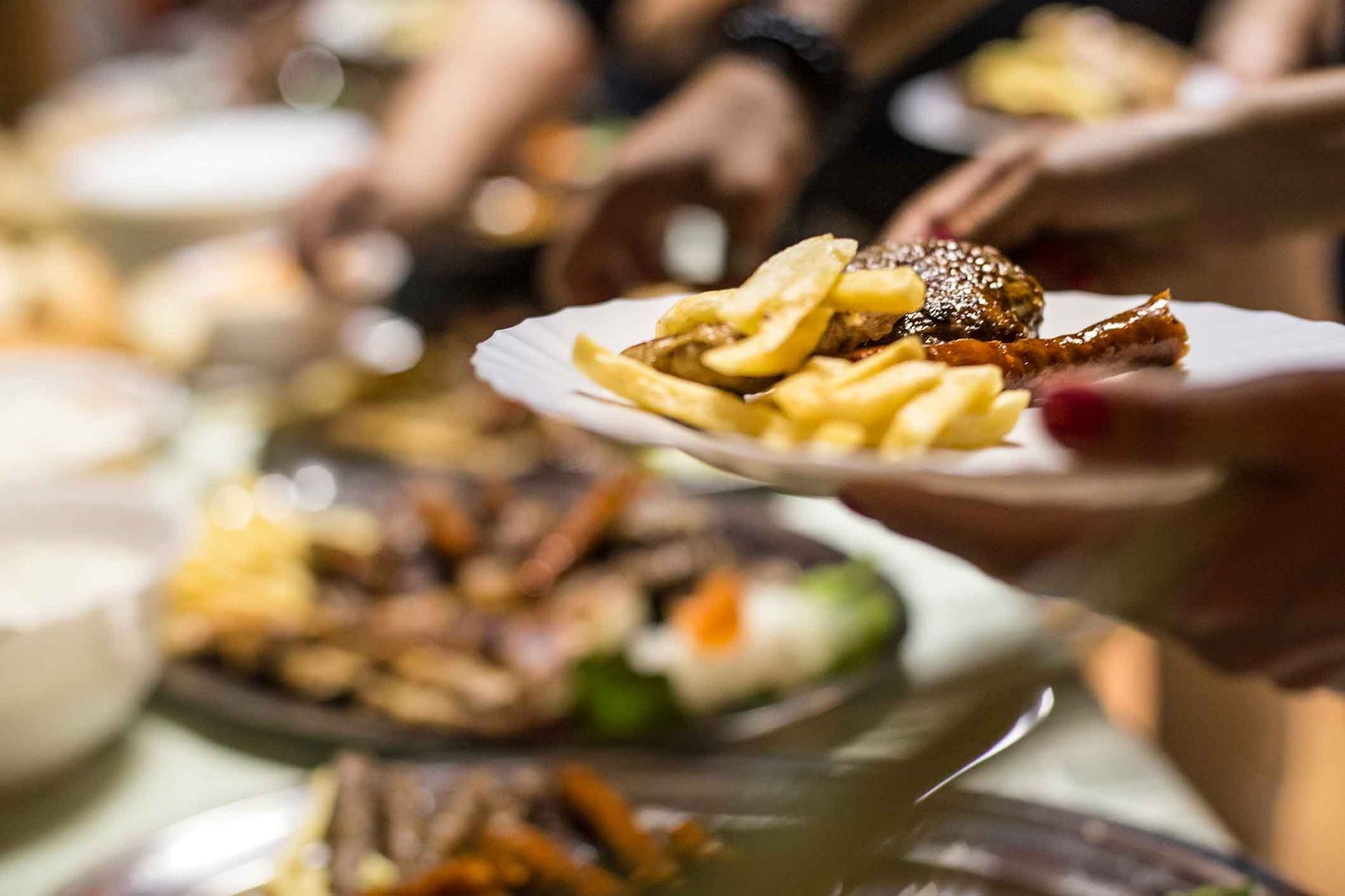 A person is holding a plate of food in their hand.