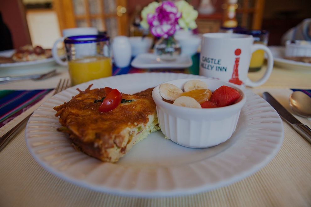 Breakfast plate with toast, strawberries, and a cup on a dining table