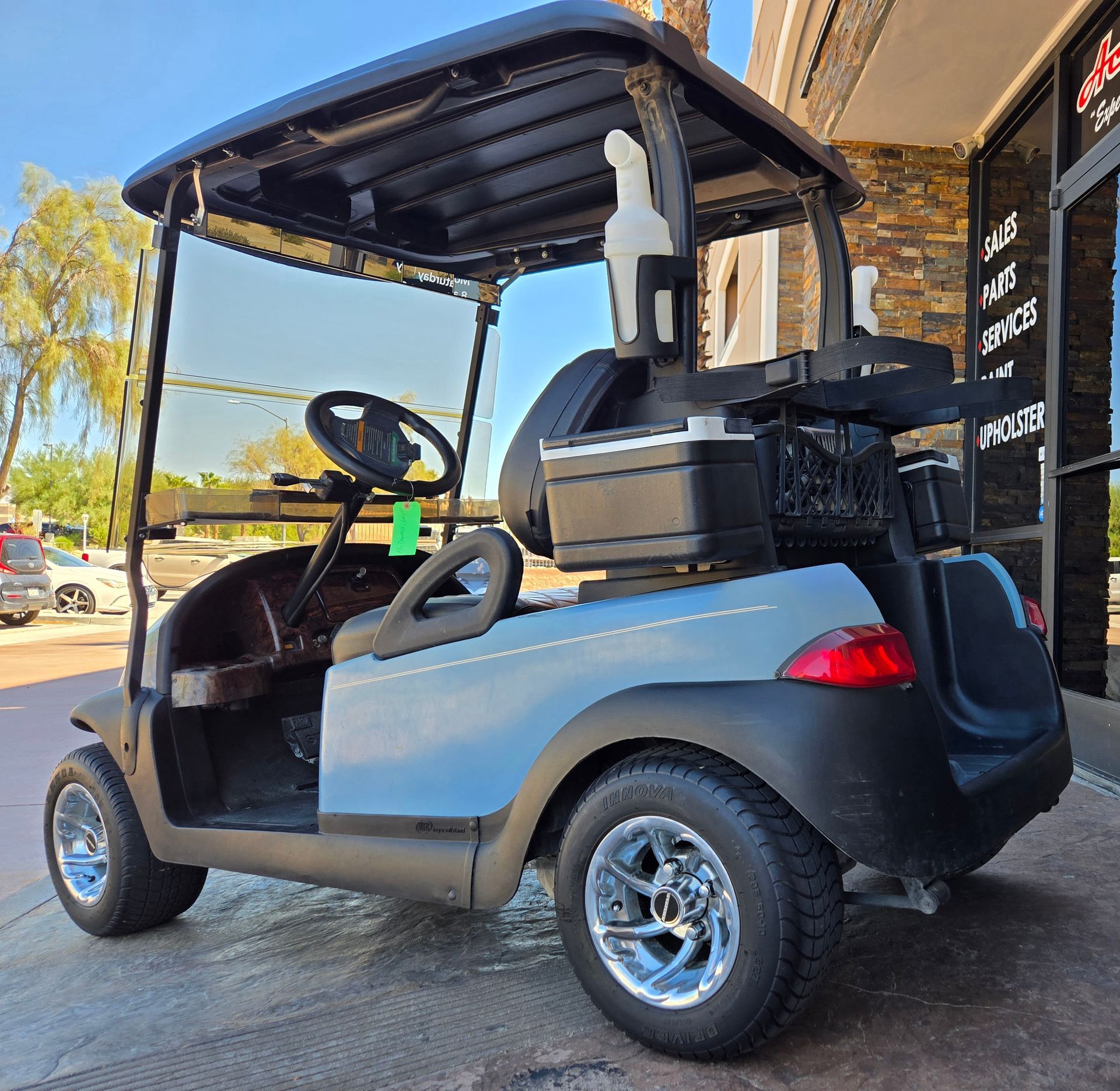 A golf cart is parked in front of a building.