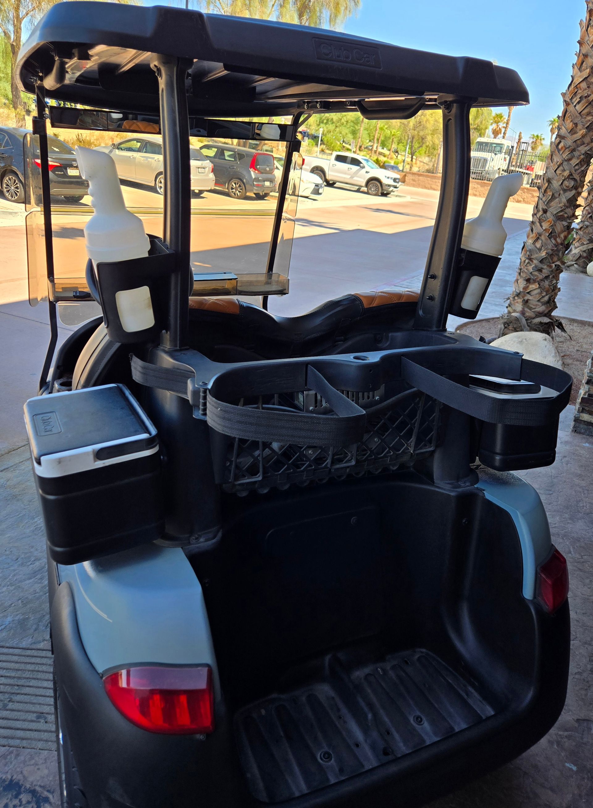 A golf cart is parked on the side of the road.