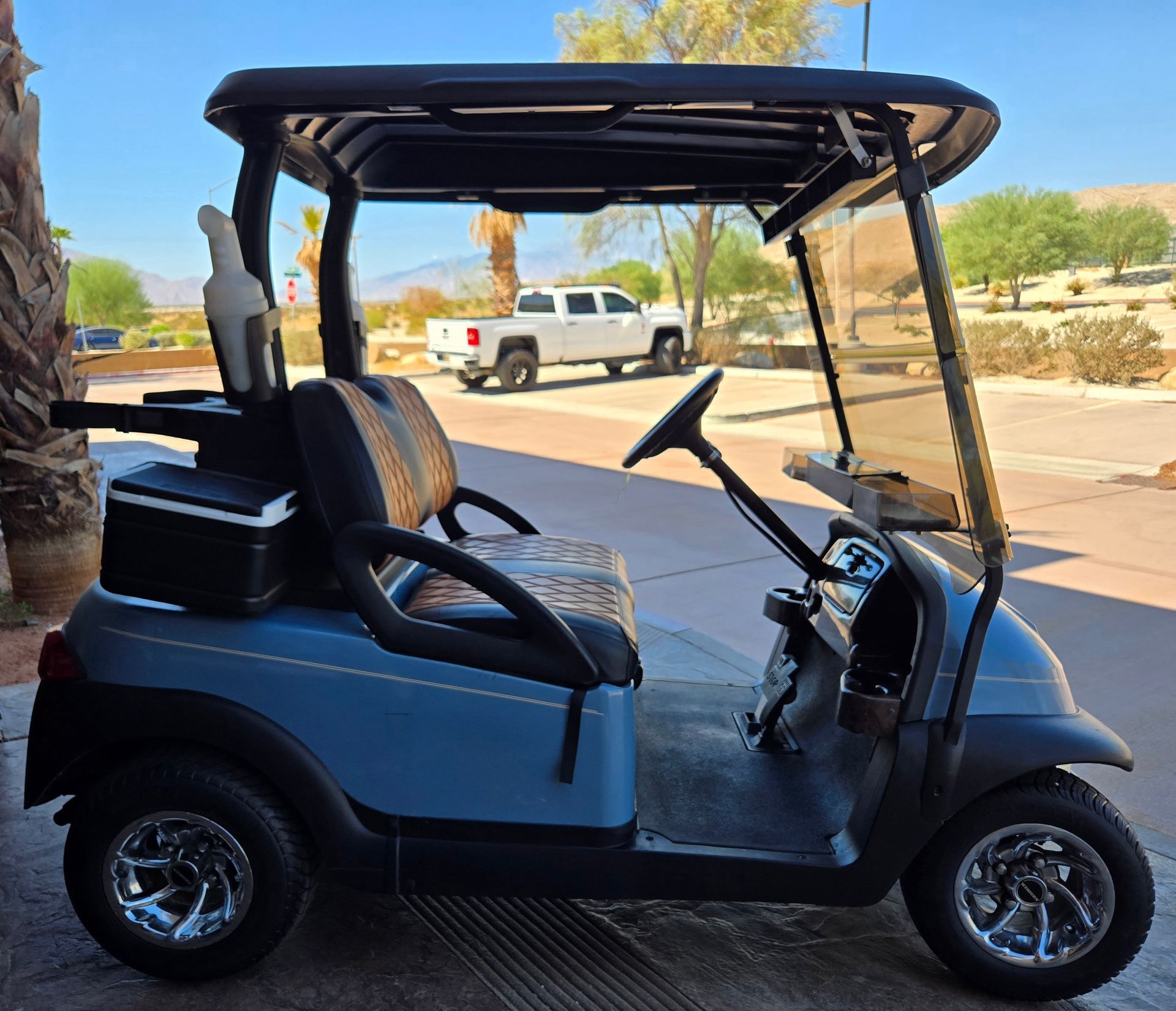 A golf cart is parked on the side of the road