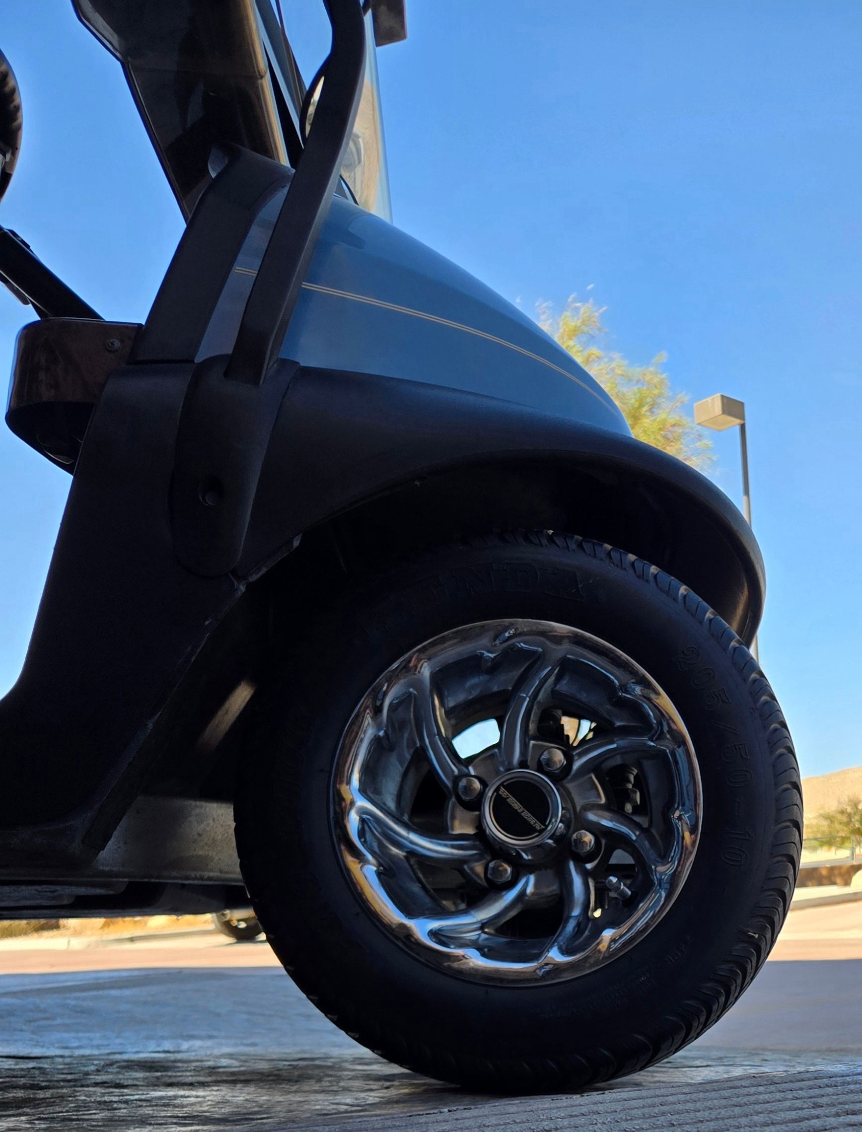 A golf cart is parked on the side of the road
