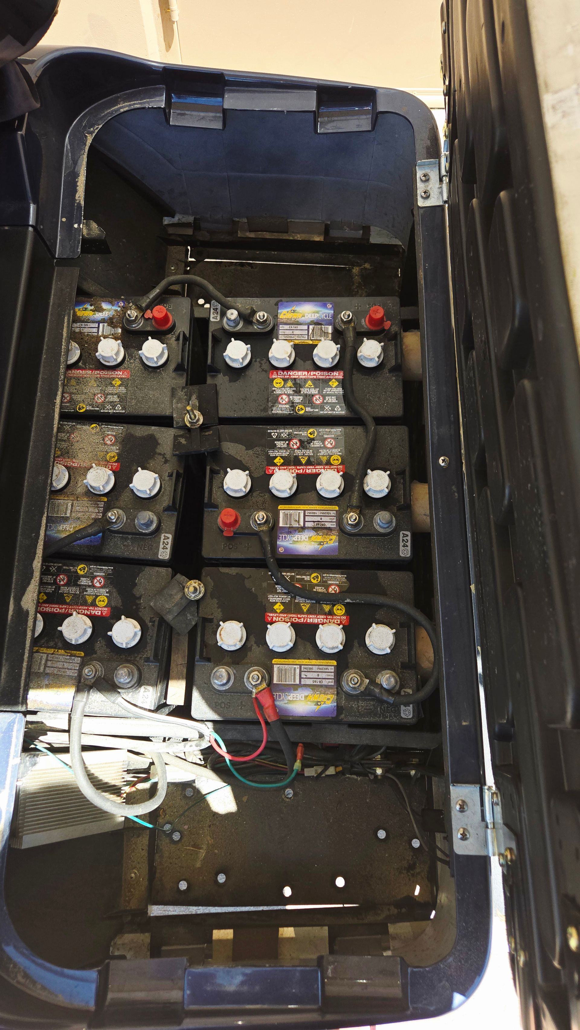 A bunch of batteries are sitting inside of a blue container.