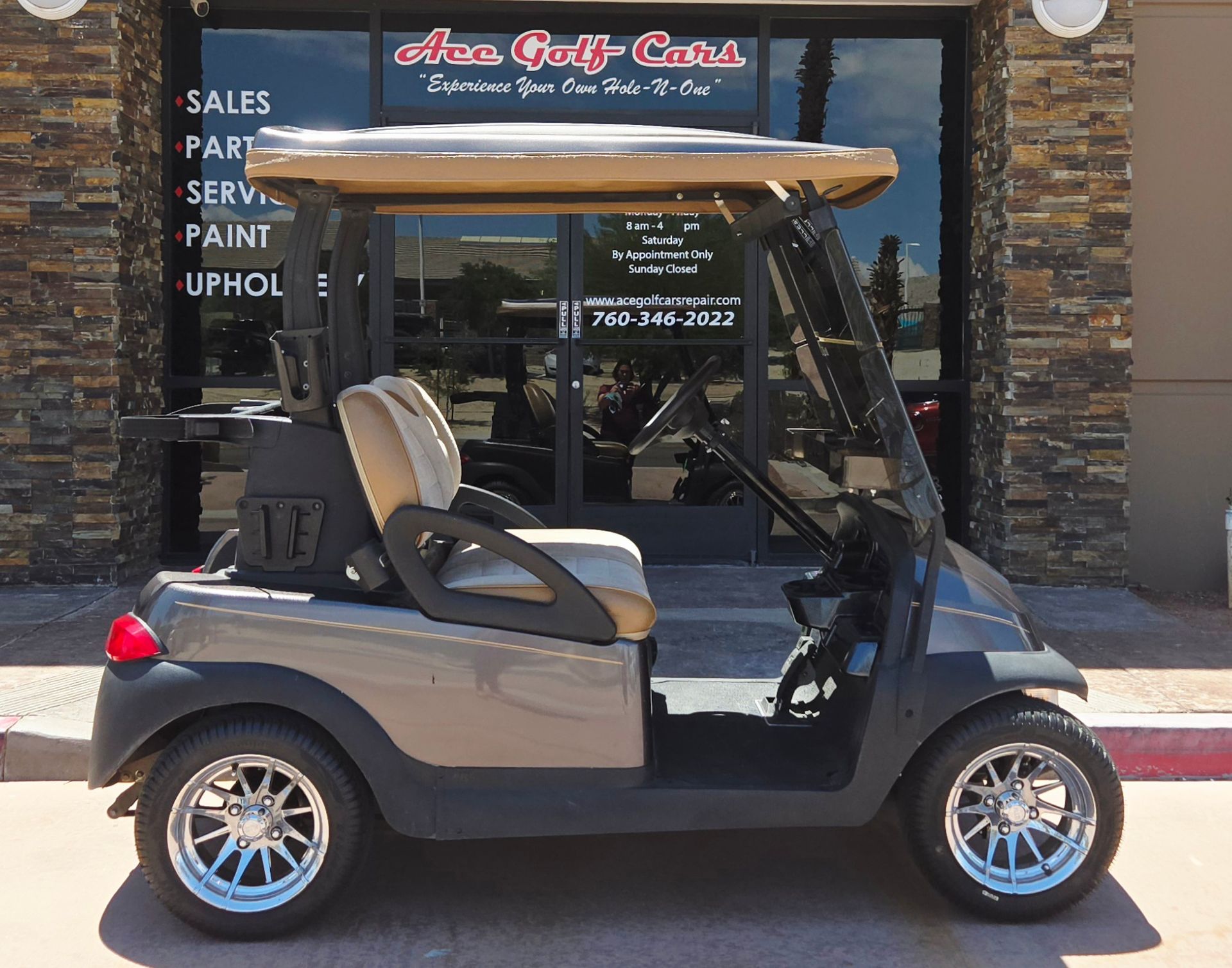 A golf cart is parked in front of a store that sells golf carts