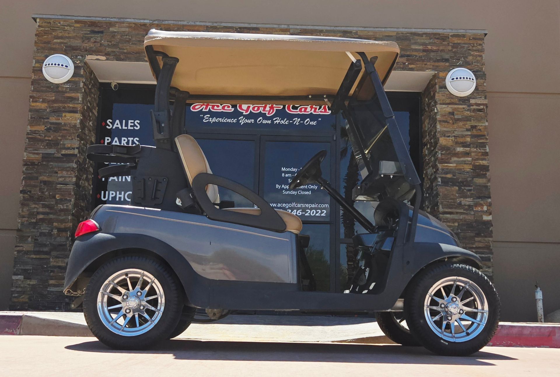 A golf cart is parked in front of a building.