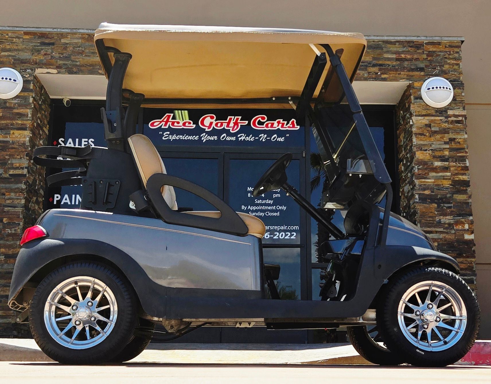 A golf cart is parked in front of a store that sells golf carts
