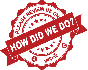 A red and white sticker that says please review us on yelp