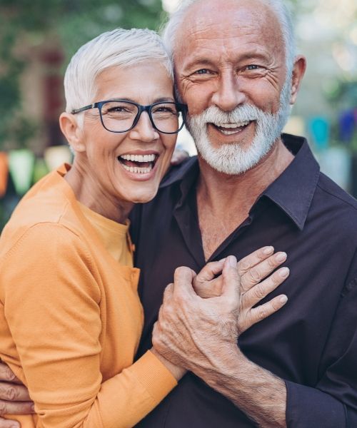 happy senior couple holding hands