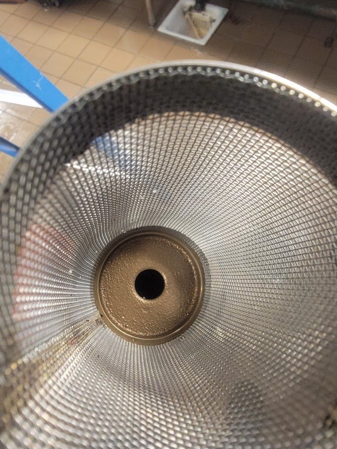 A close up of a metal object with a hole in the middle