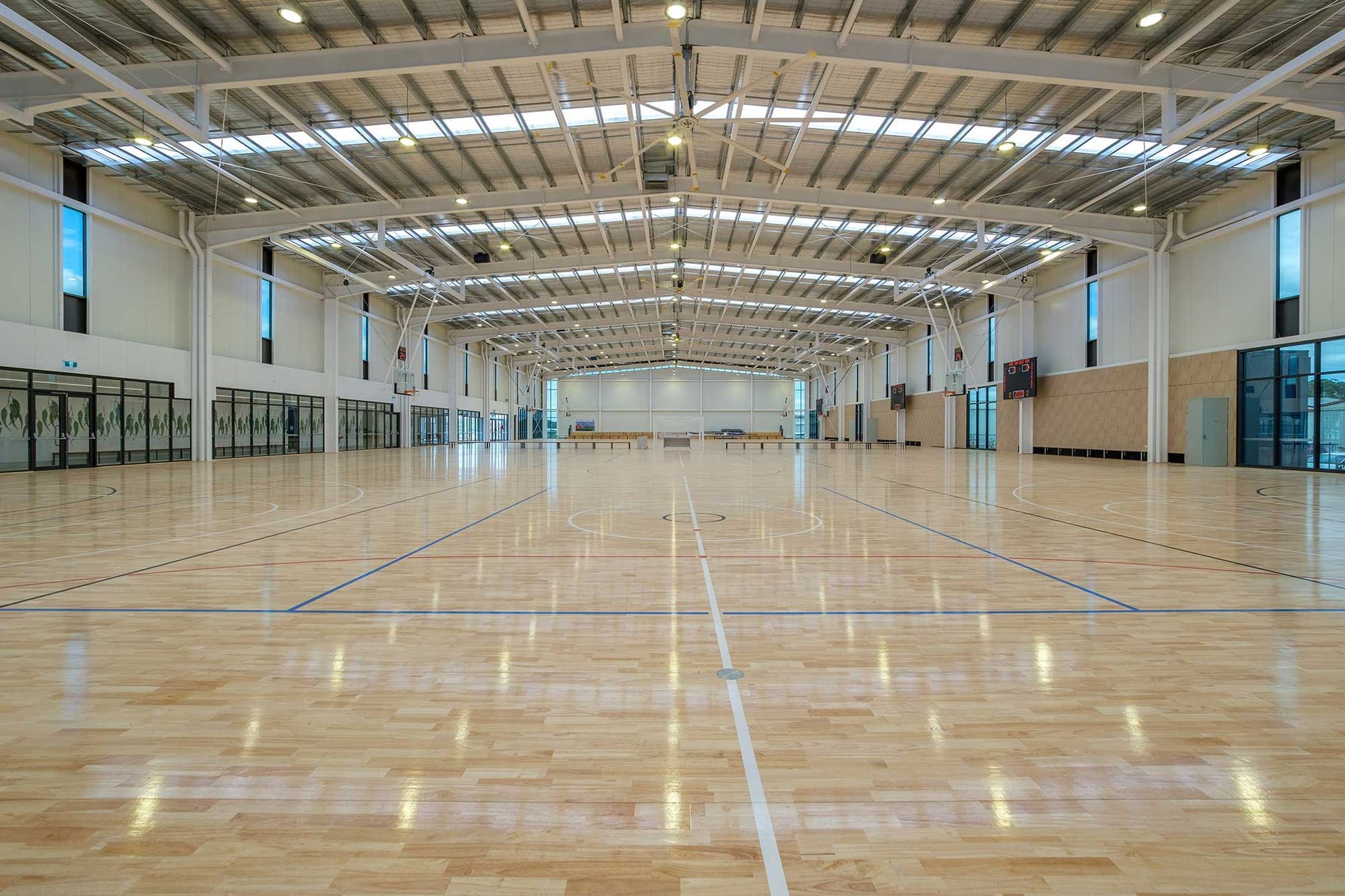 A large indoor basketball court with a wooden floor.