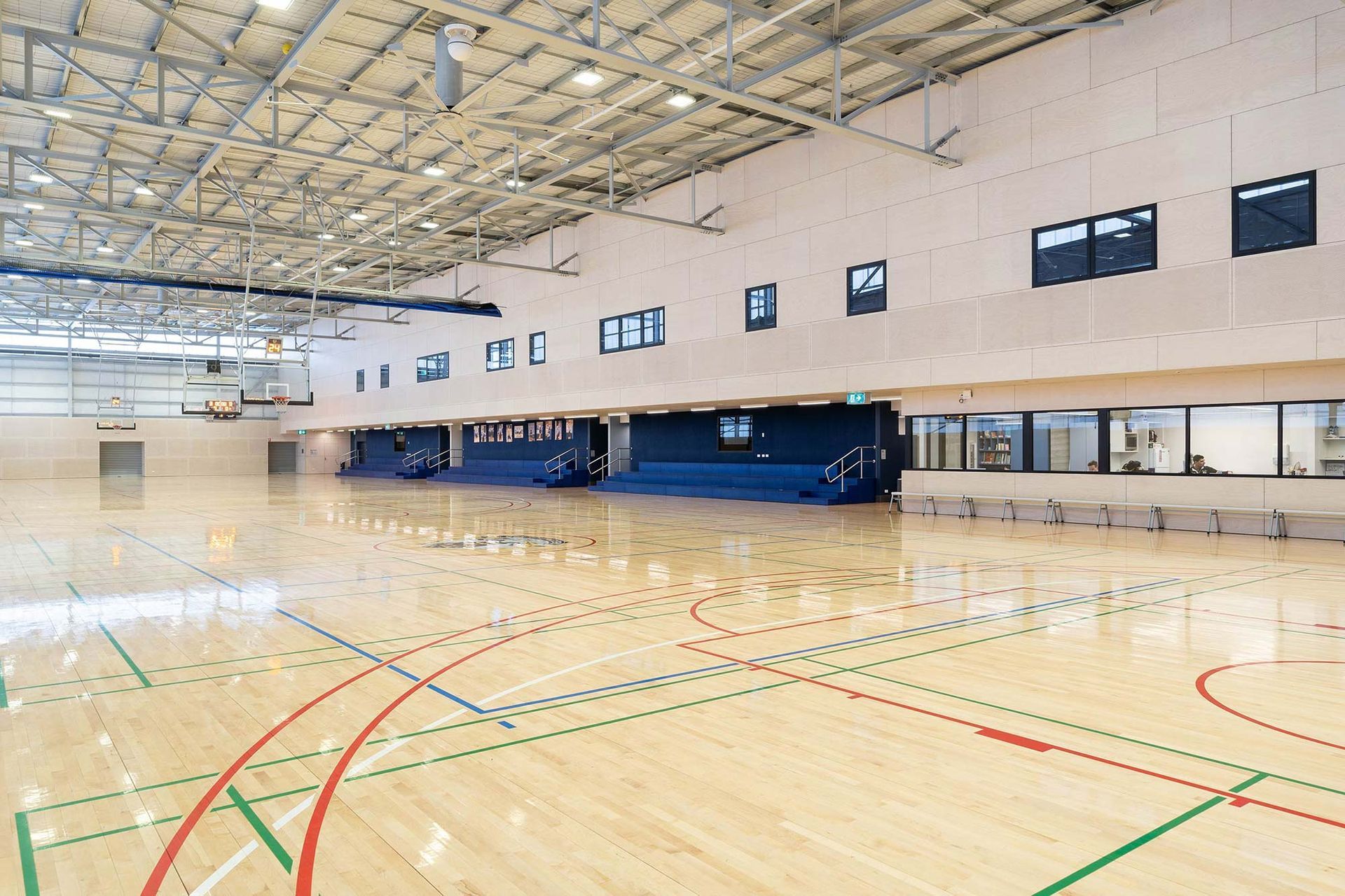 A large indoor basketball court with a wooden floor.