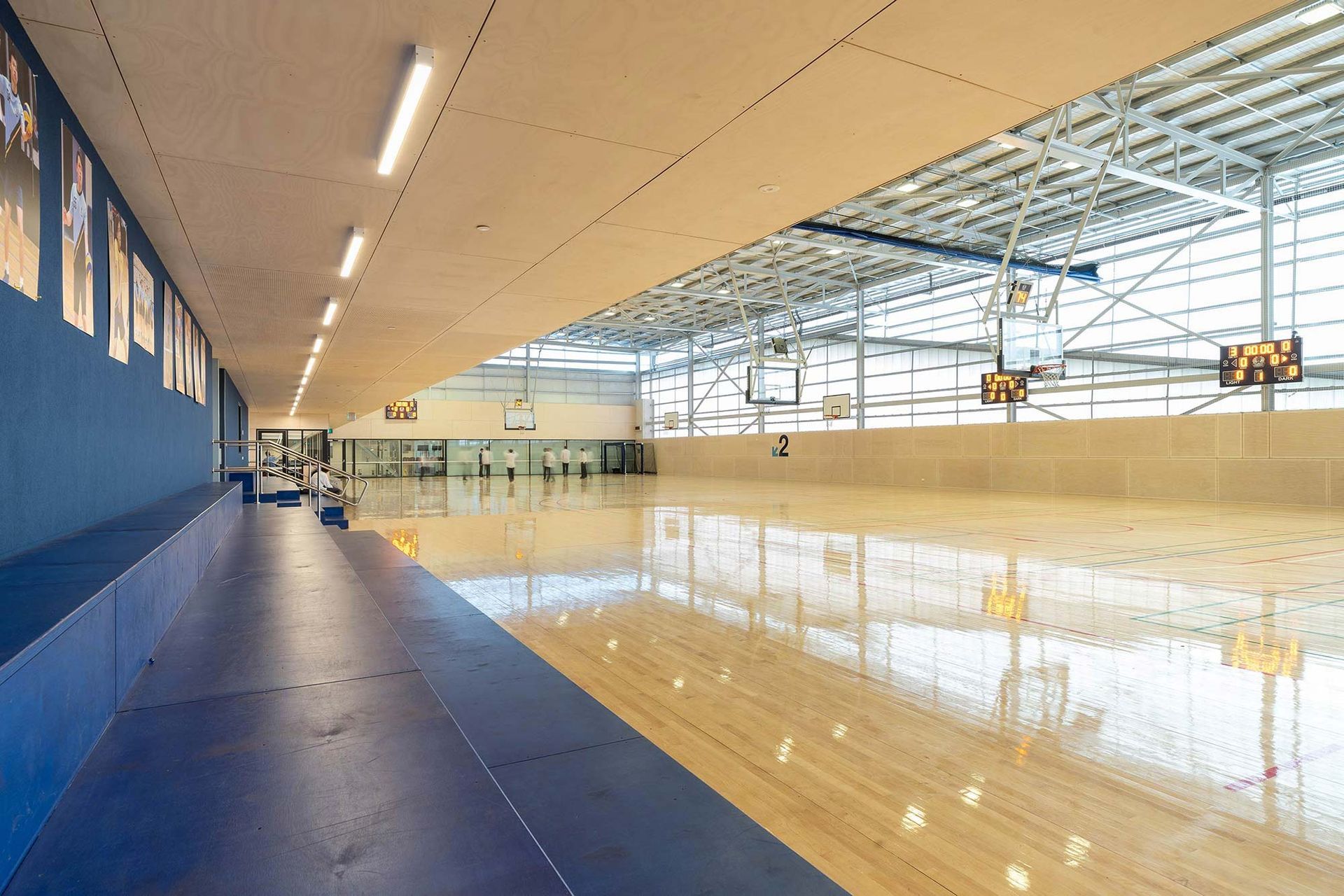 A large indoor basketball court with a wooden floor.