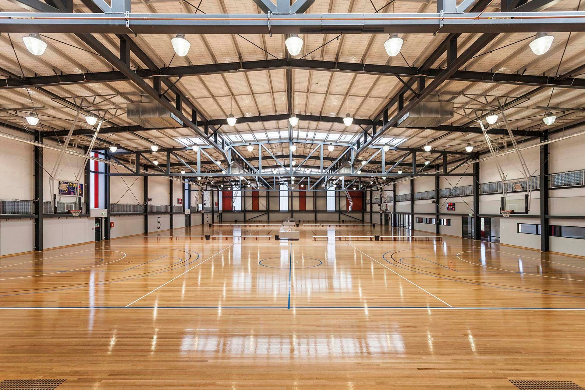 A large indoor basketball court with a wooden floor.