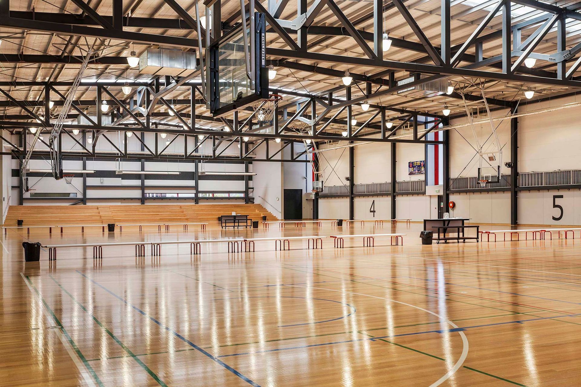 An empty basketball court with the number 5 on the wall.