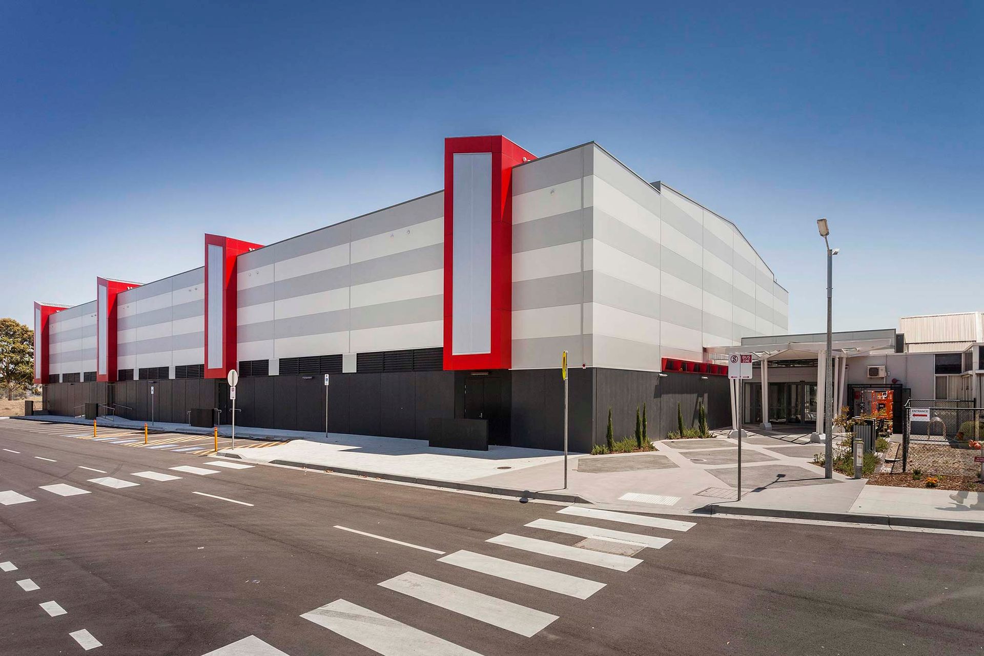 A large building with a red and white stripe on the side of it.