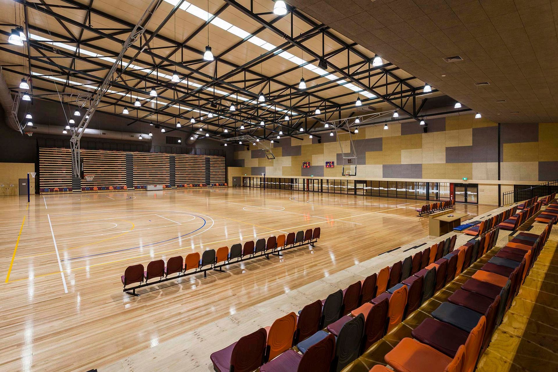 A large indoor stadium with rows of seats and a basketball court.