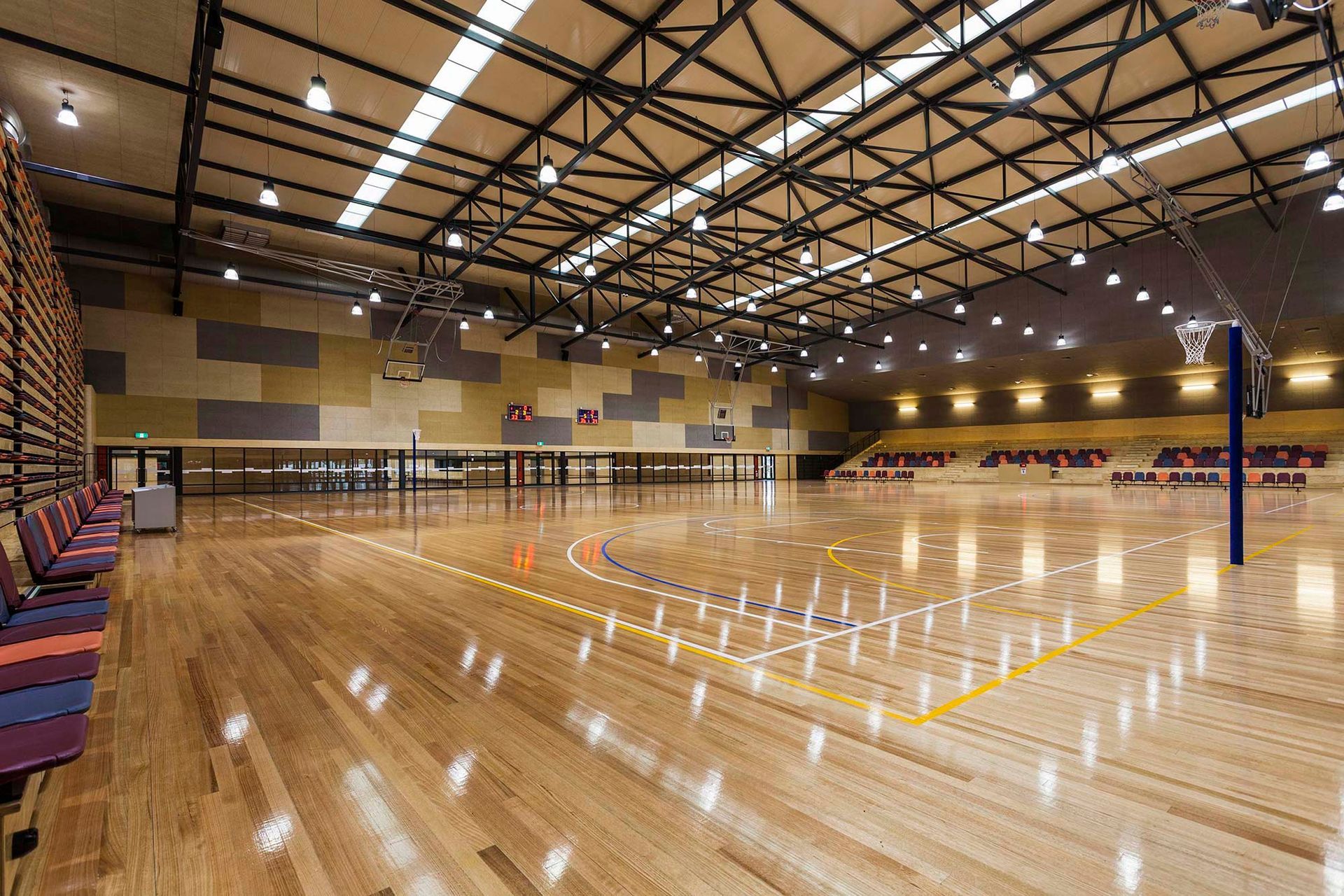 A large indoor basketball court with a wooden floor