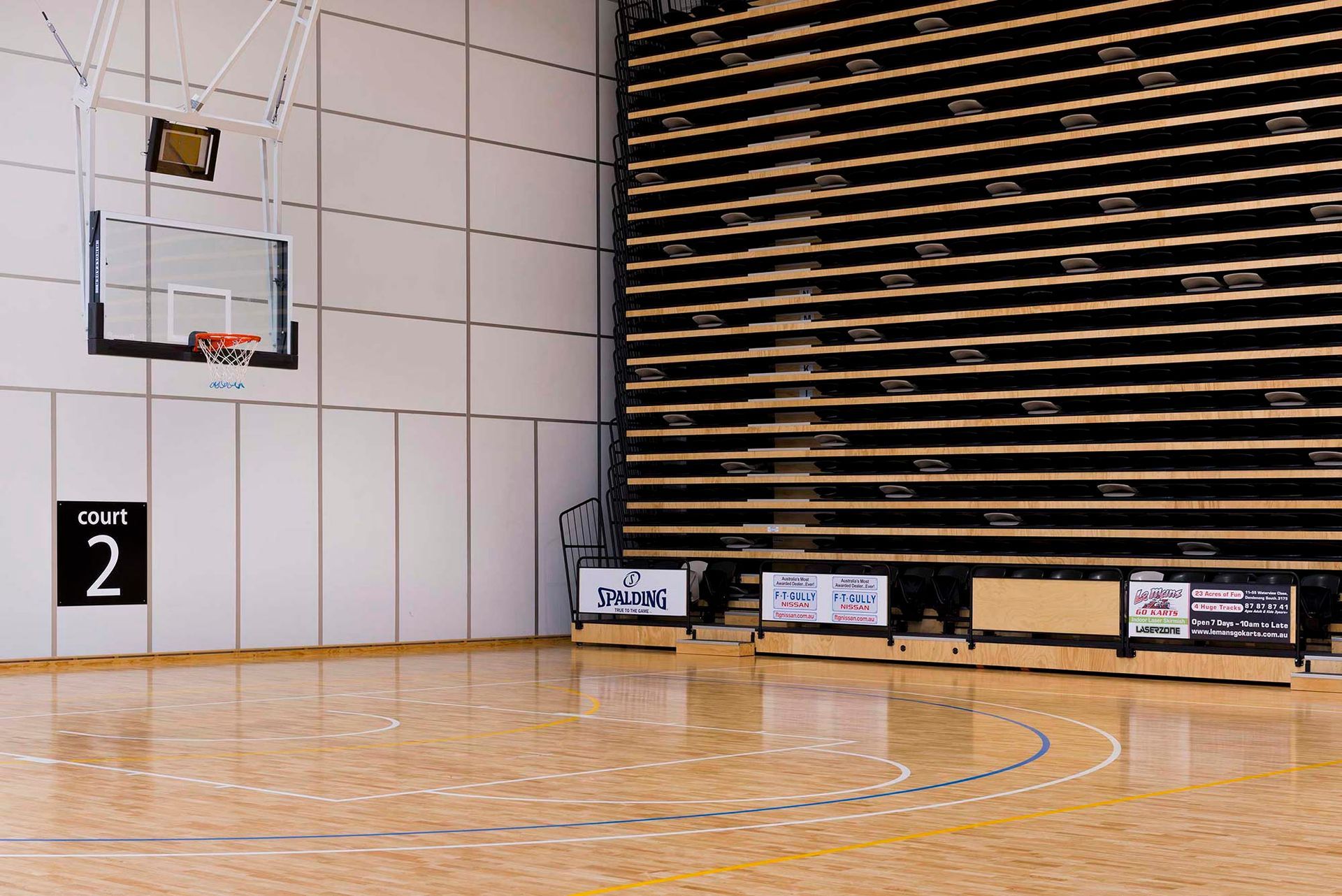 An empty basketball court with the number 2 on the wall