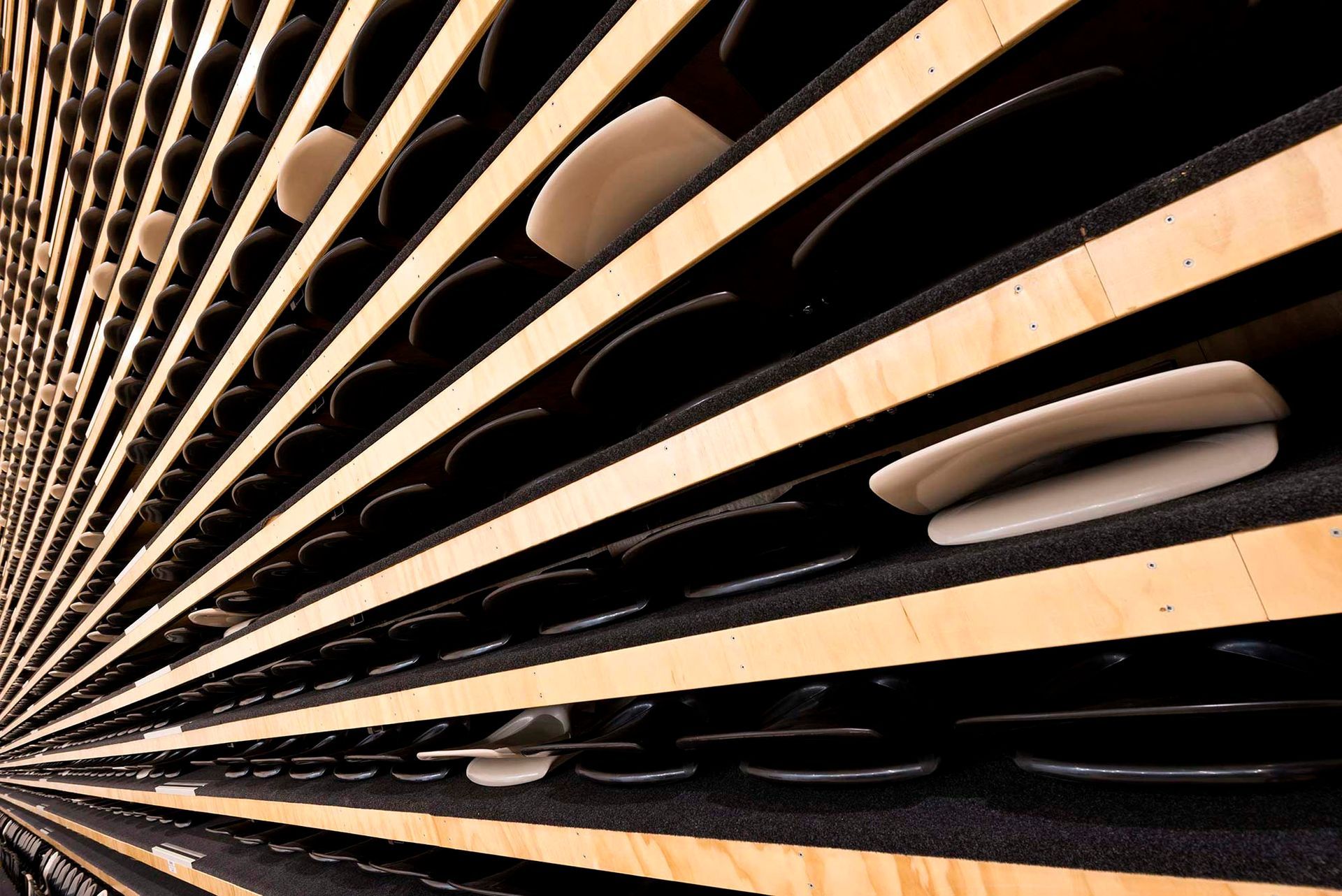 A bunch of plates are lined up on a shelf