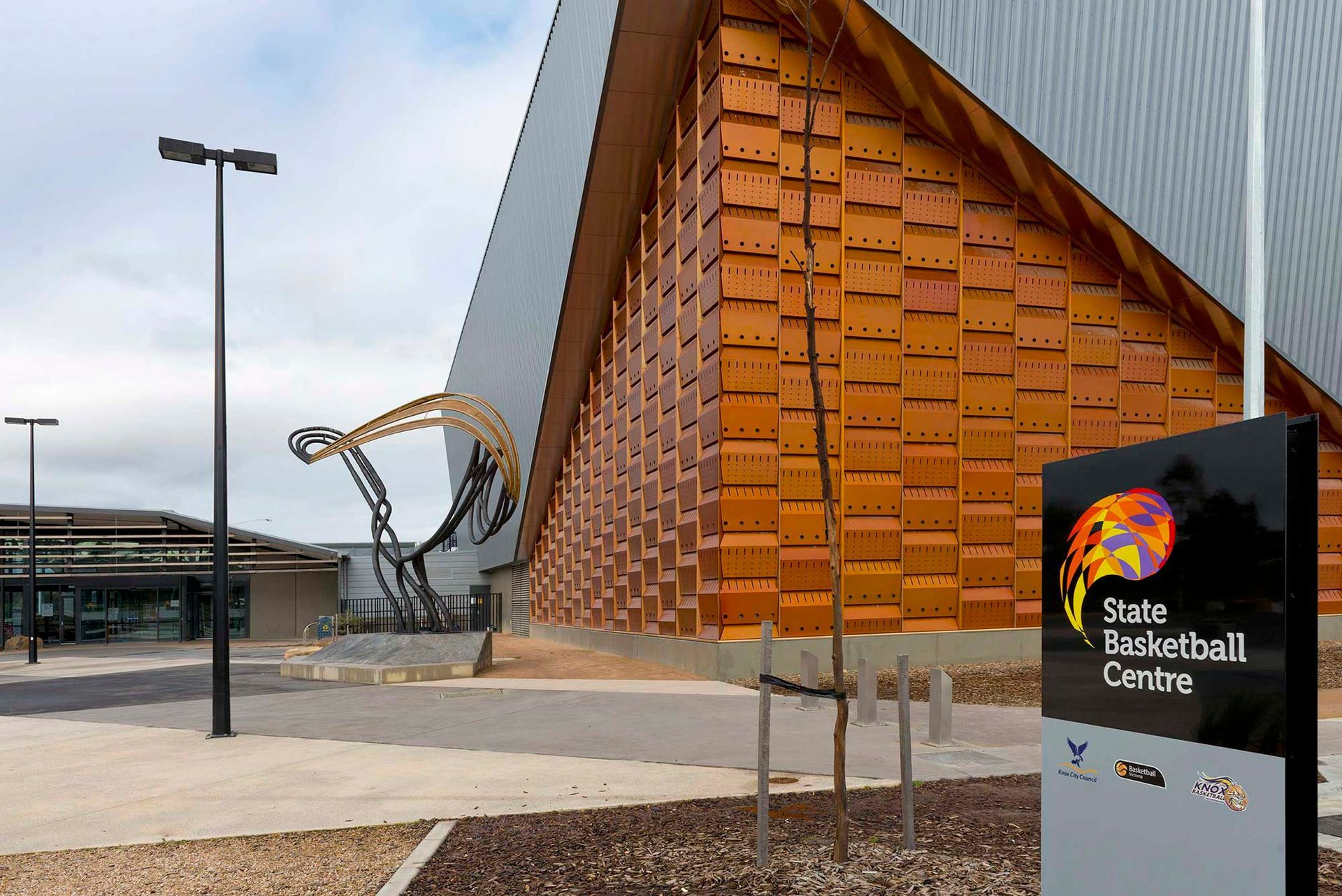 A large building with a sign that says state basketball centre