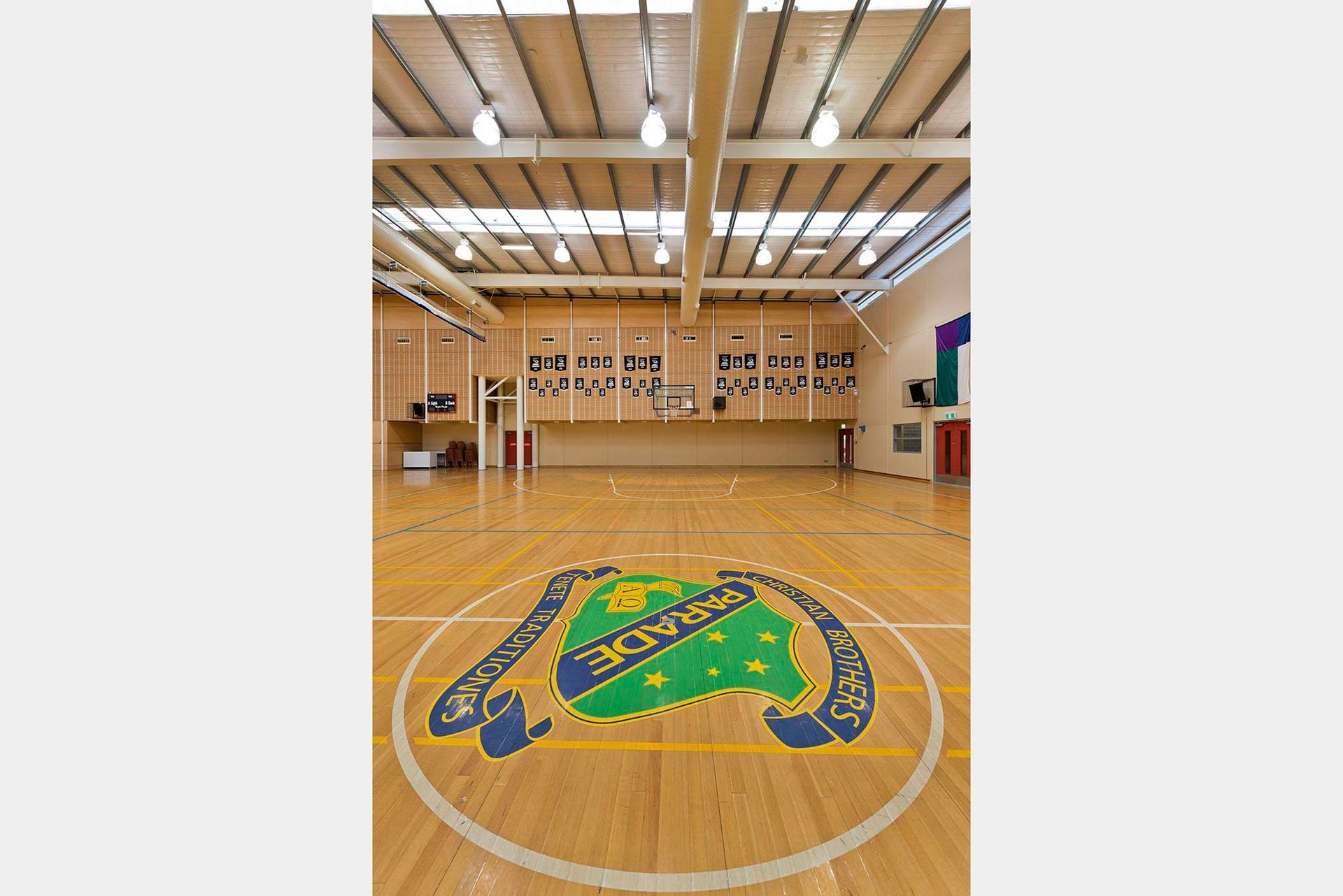 A basketball court with a logo on the floor.