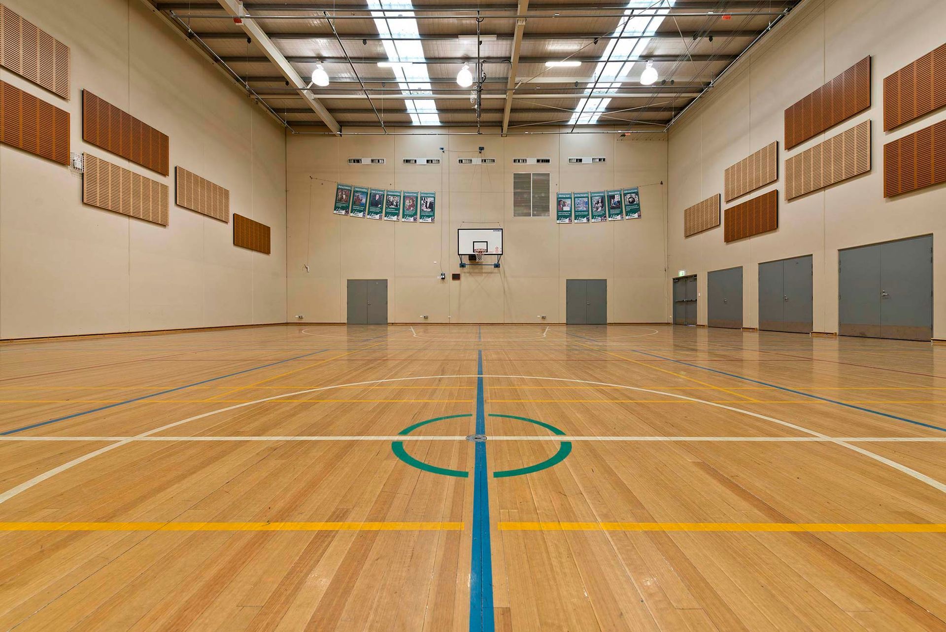 An empty basketball court with a blue line in the middle