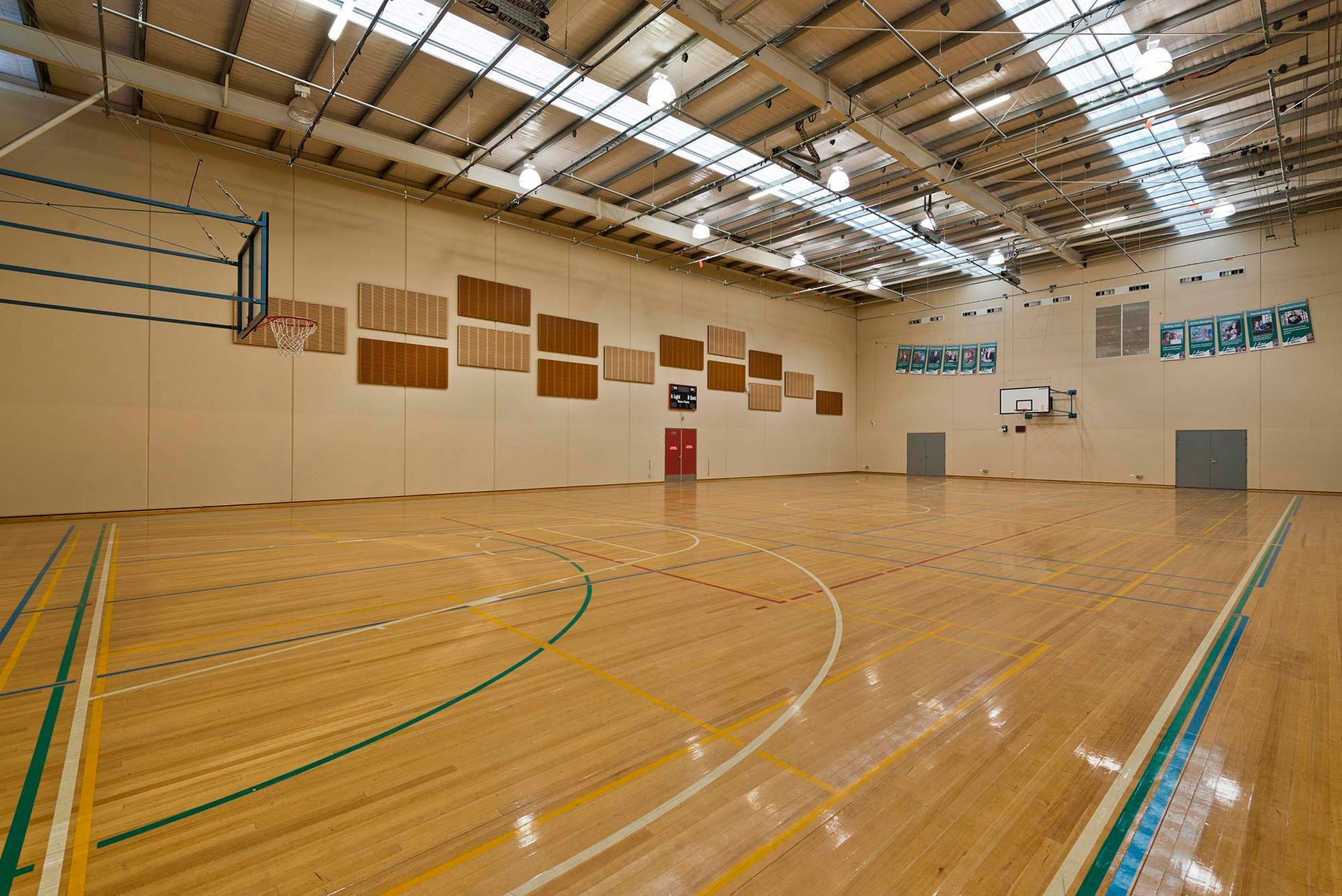 A large indoor basketball court with a wooden floor