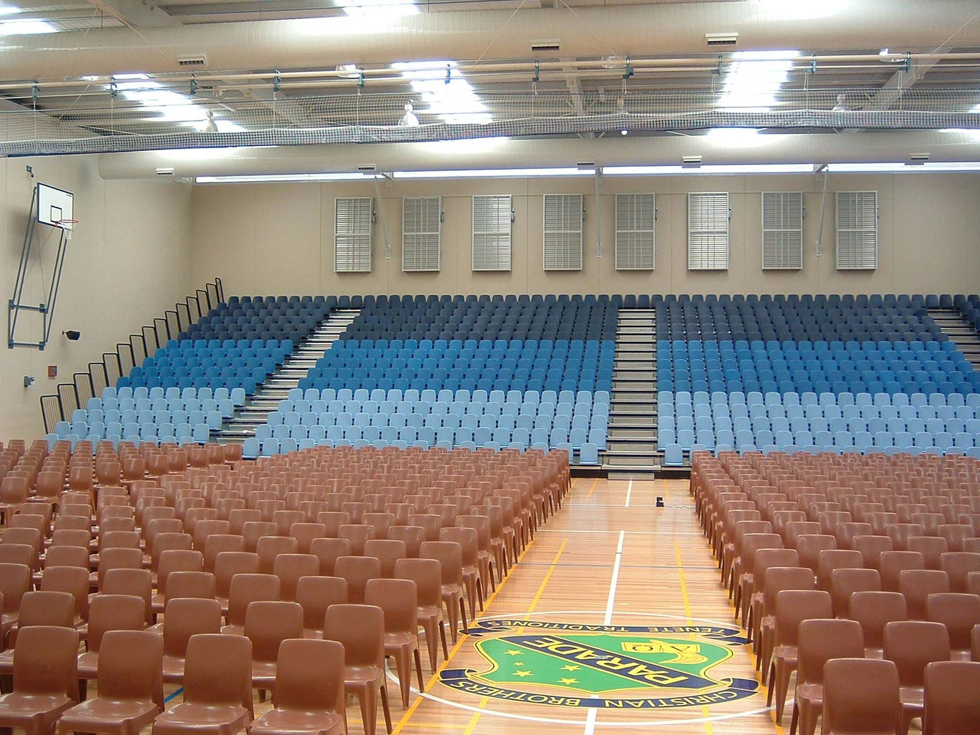 A large auditorium with rows of blue and brown seats