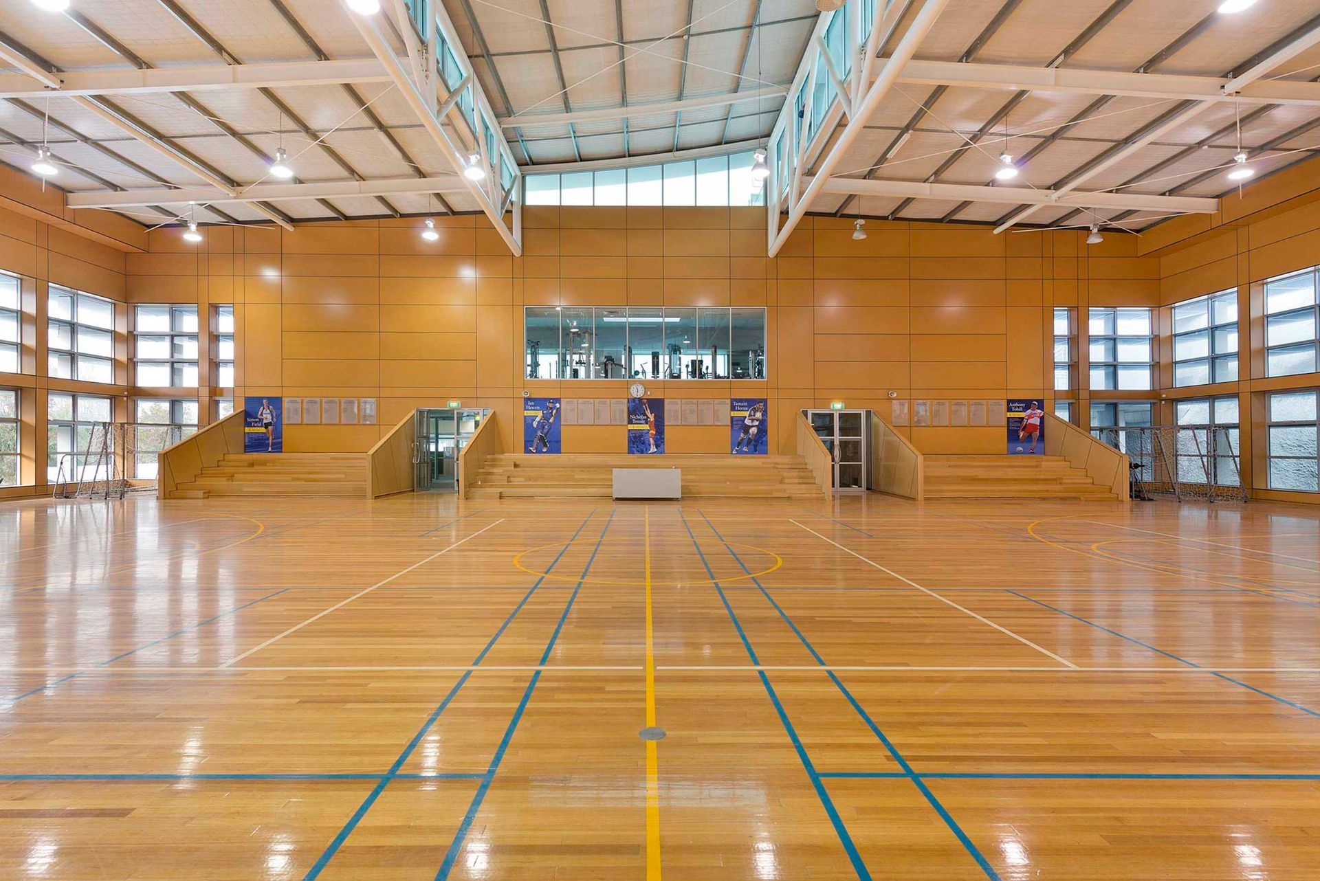 A large indoor basketball court with a wooden floor