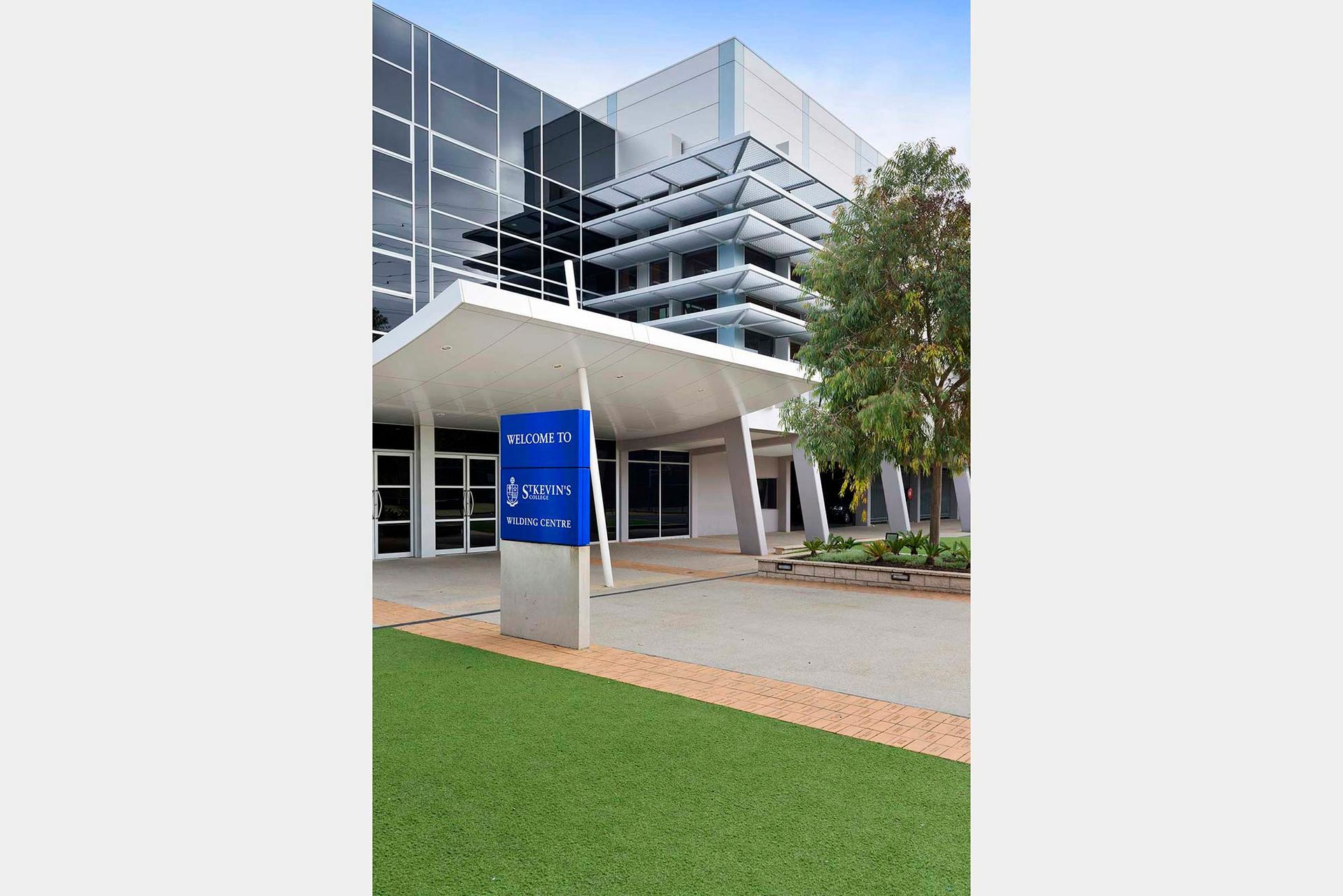 A large building with a blue sign in front of it