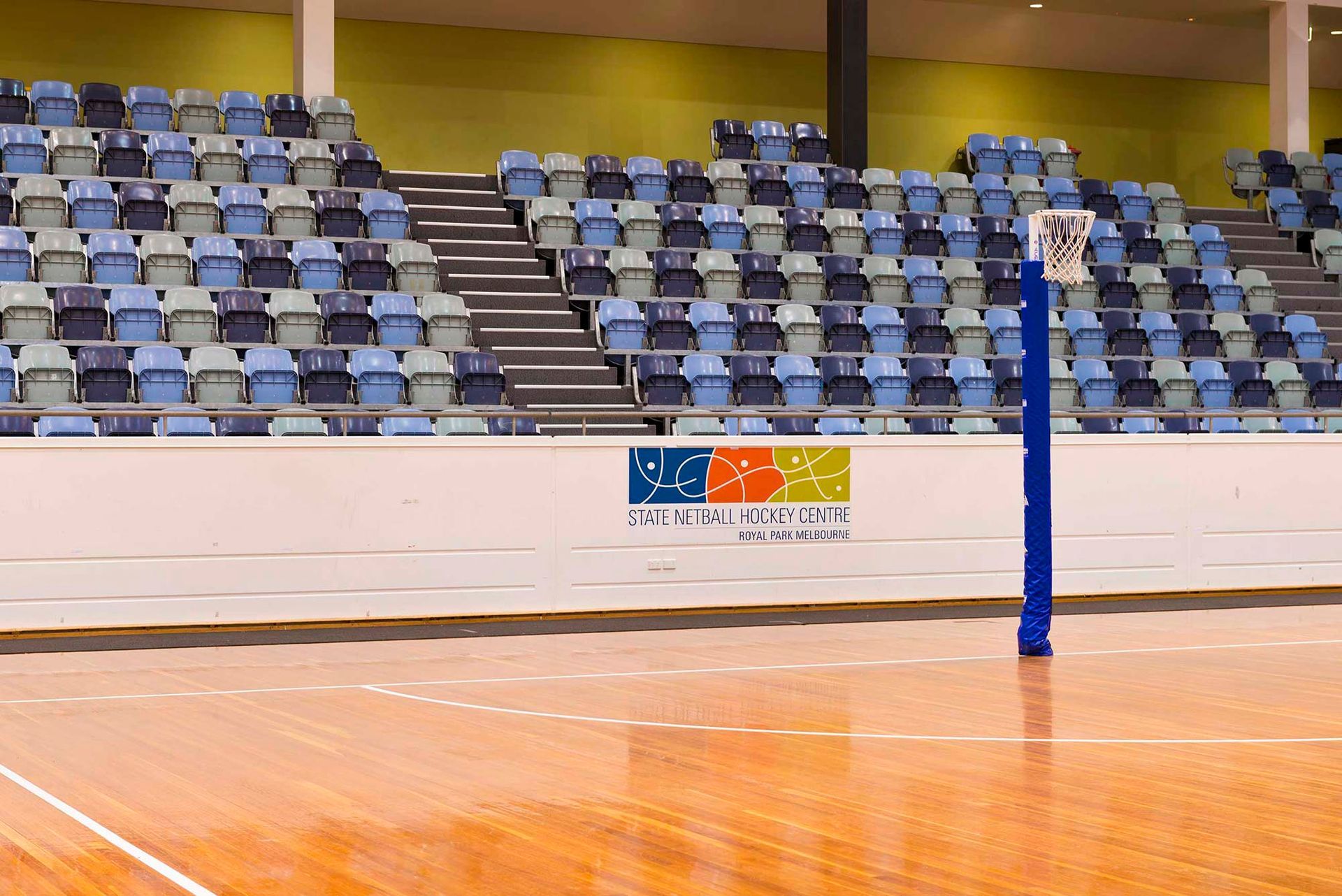 An empty stadium with a basketball hoop in the middle