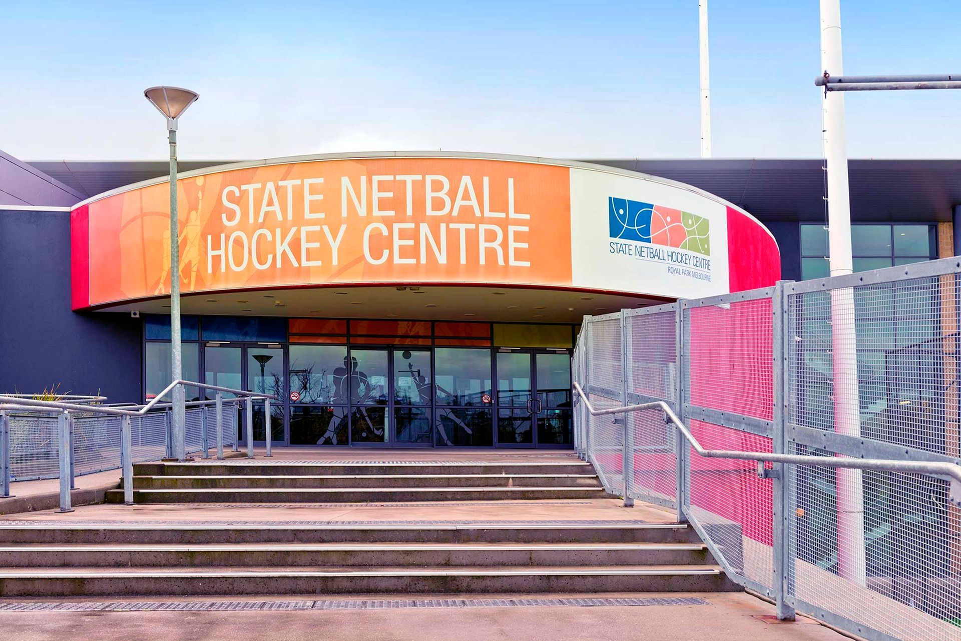 The entrance to the state netball hockey centre with stairs leading up to it.