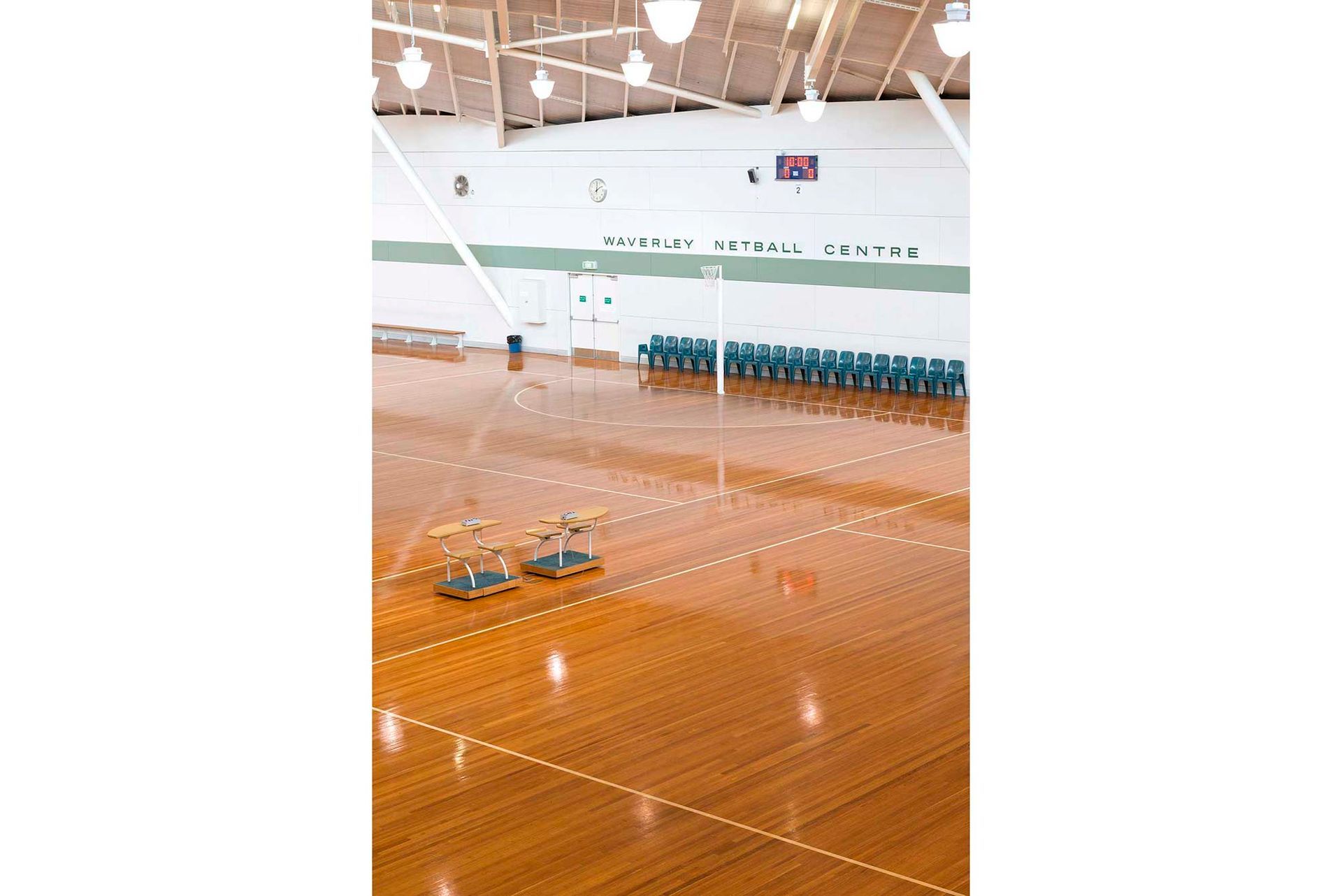 A large indoor basketball court with a wooden floor