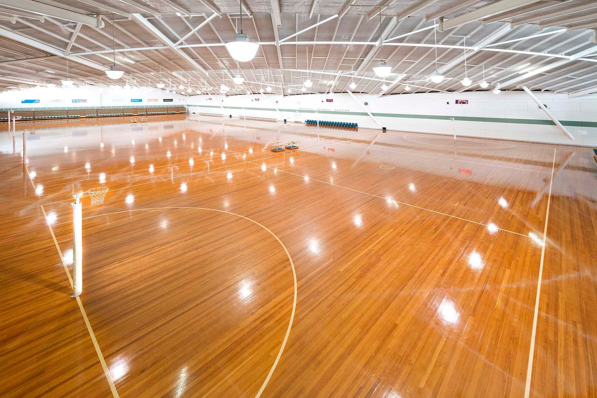 A large indoor basketball court with a wooden floor.