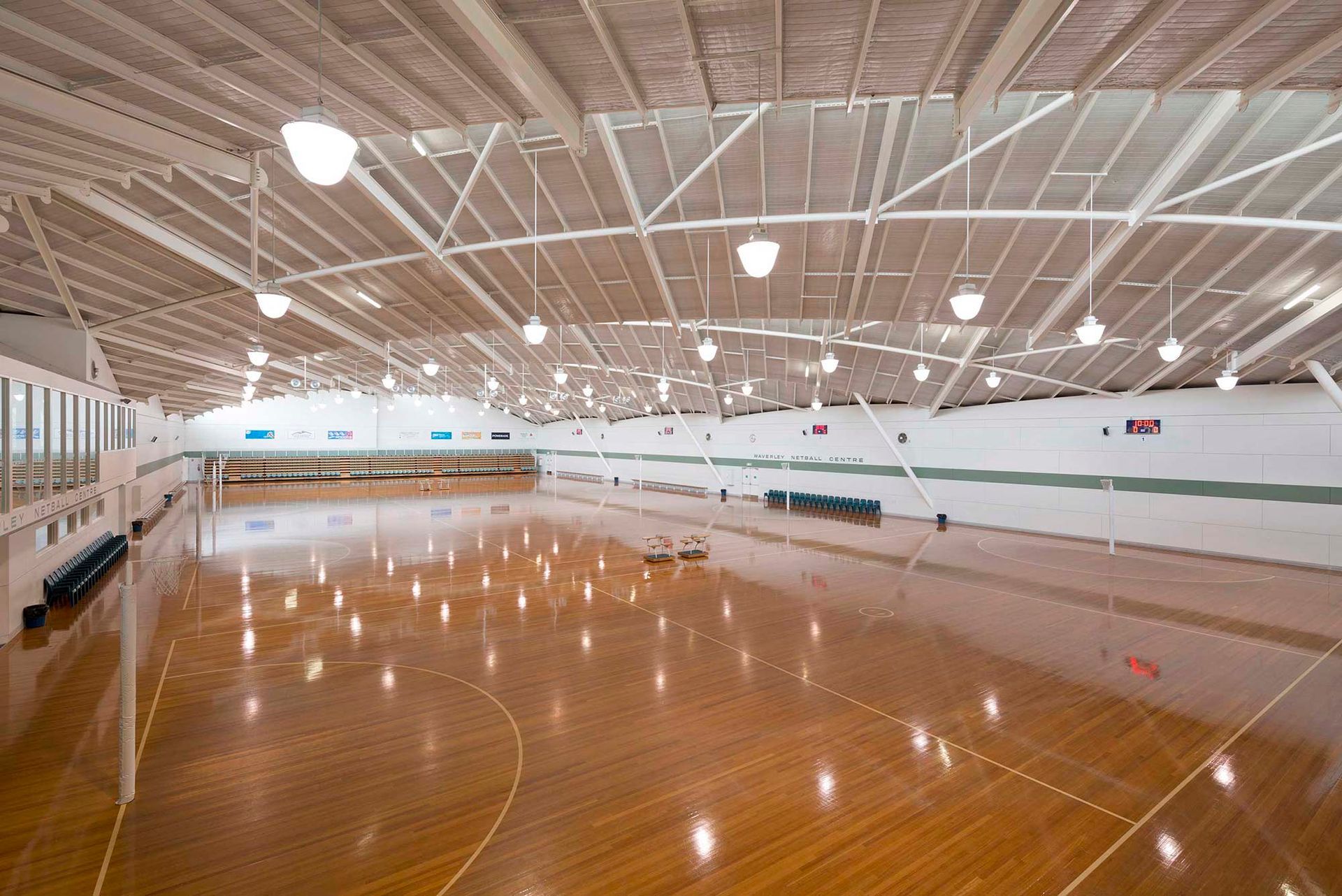 A large indoor basketball court with a wooden floor