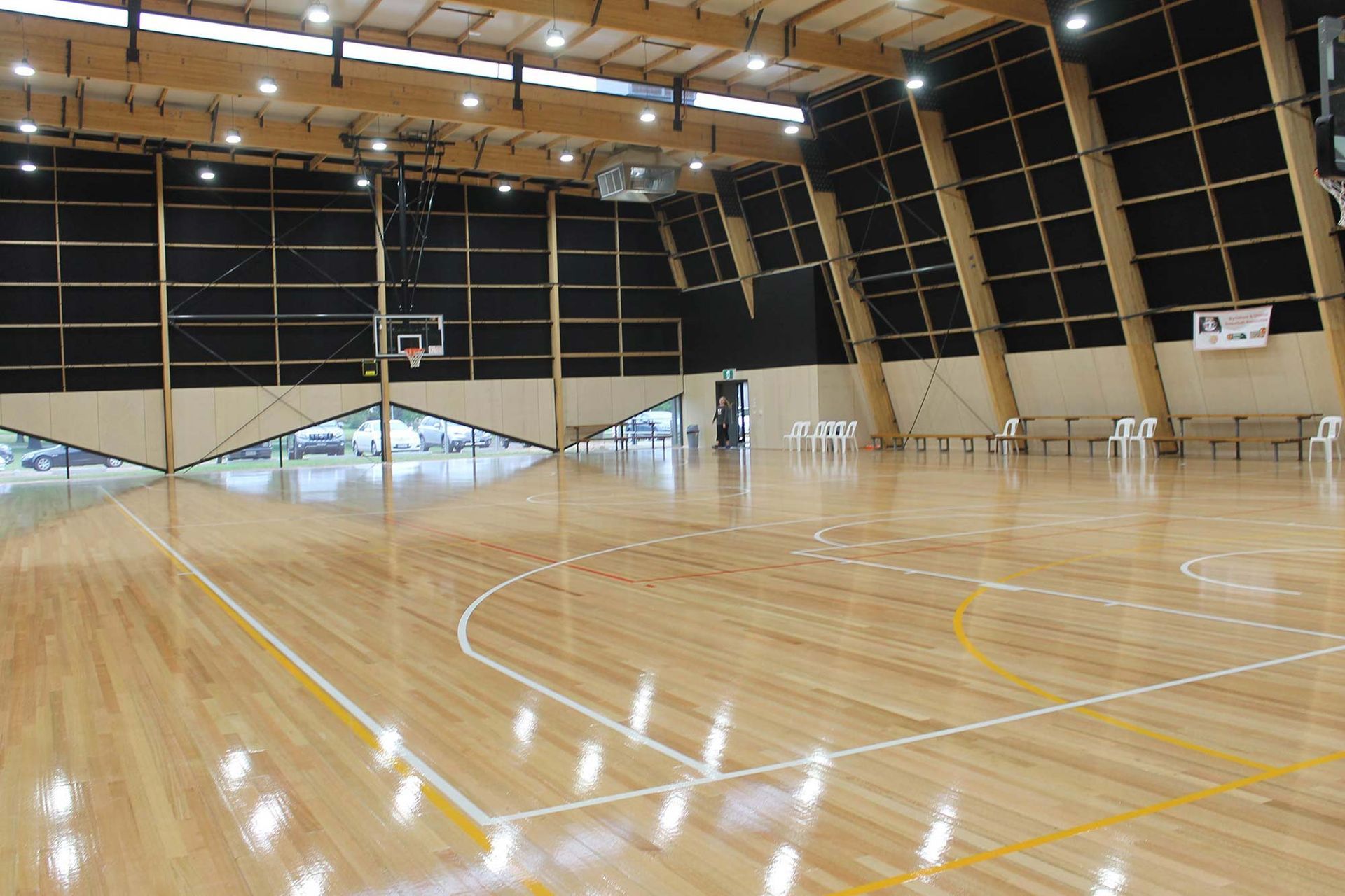 A large indoor basketball court with a wooden floor
