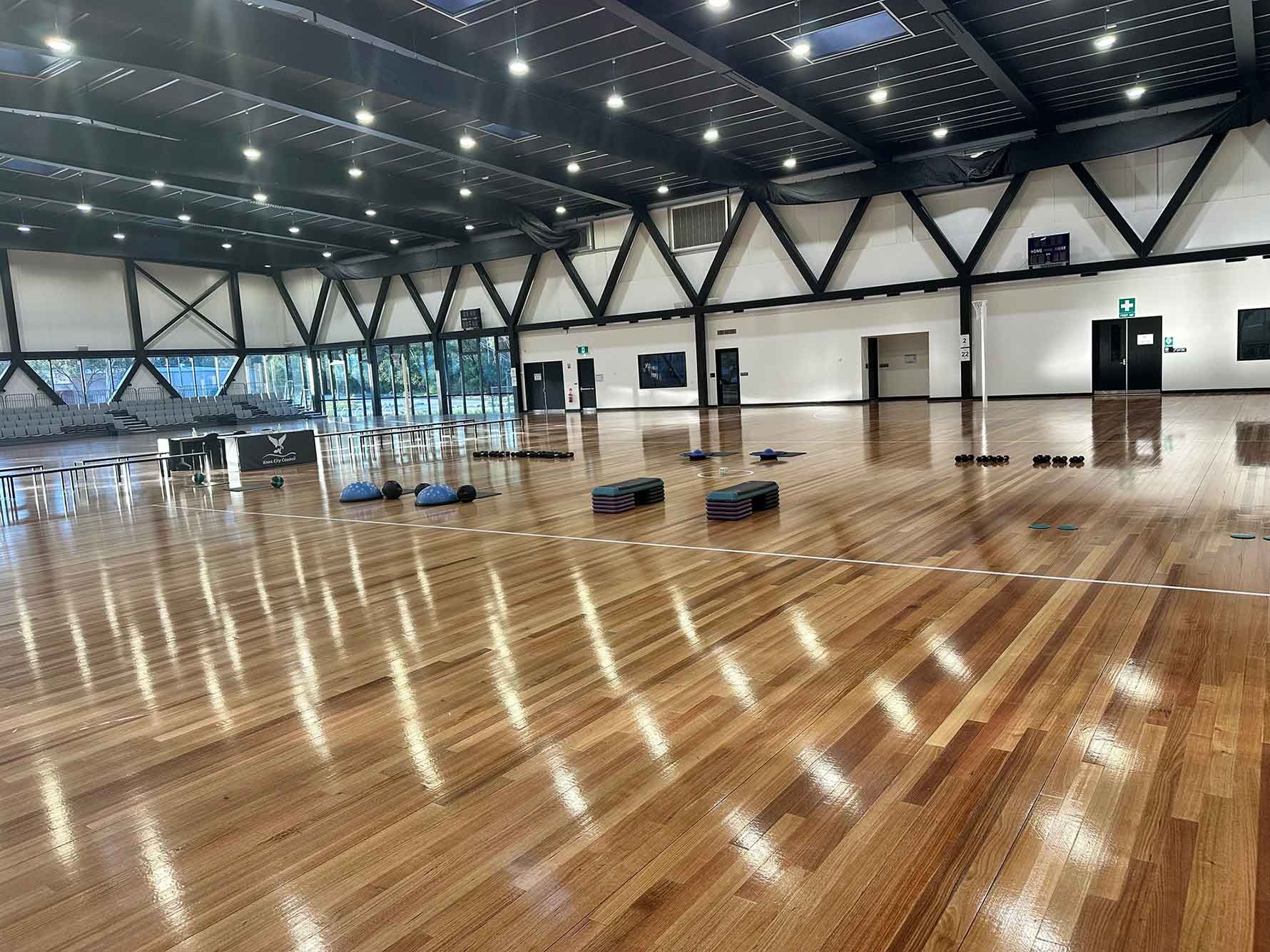 A large room with a wooden floor and a lot of lights.