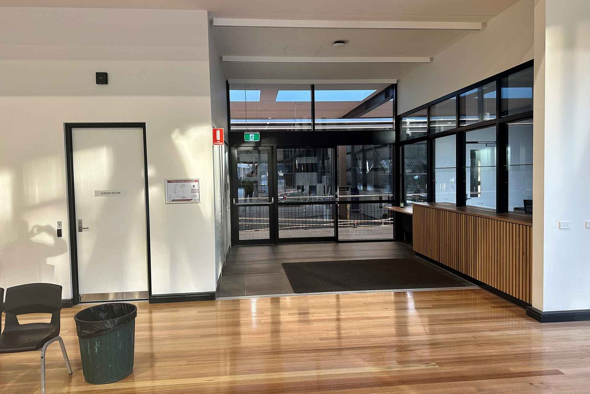 A large room with a wooden floor and a lot of windows.