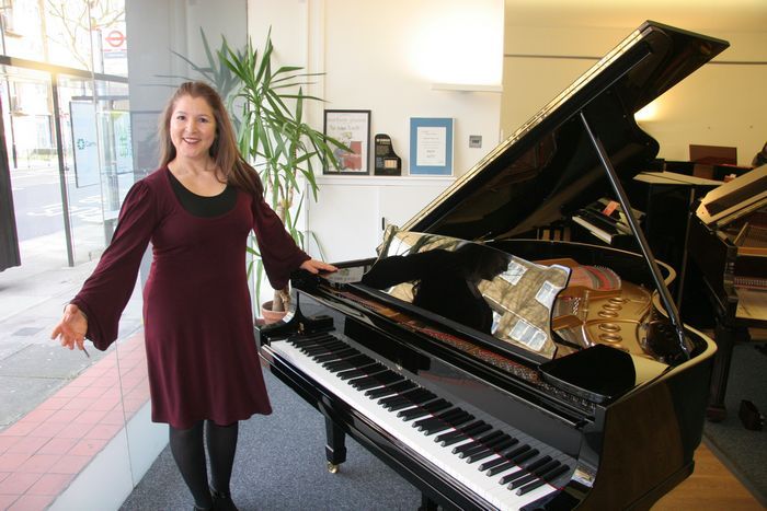 louisa beard near a piano
