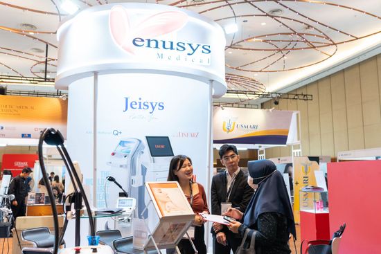 People at a booth for medical equipment with 