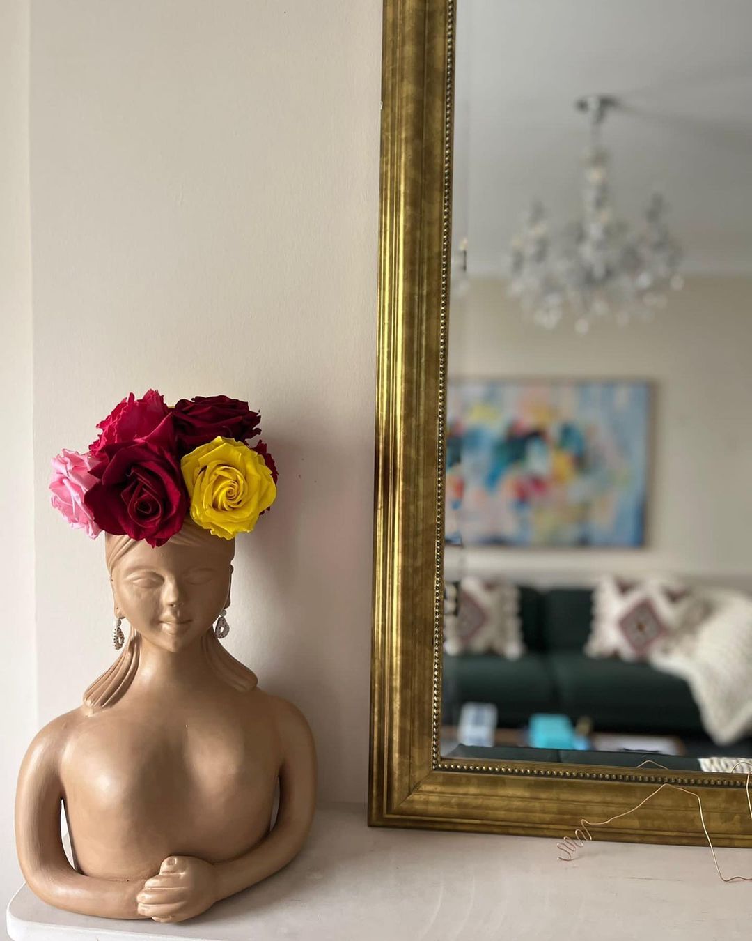 A woman-shaped vase with roses on a shelf. bespoke Infiniblooms arrangement 