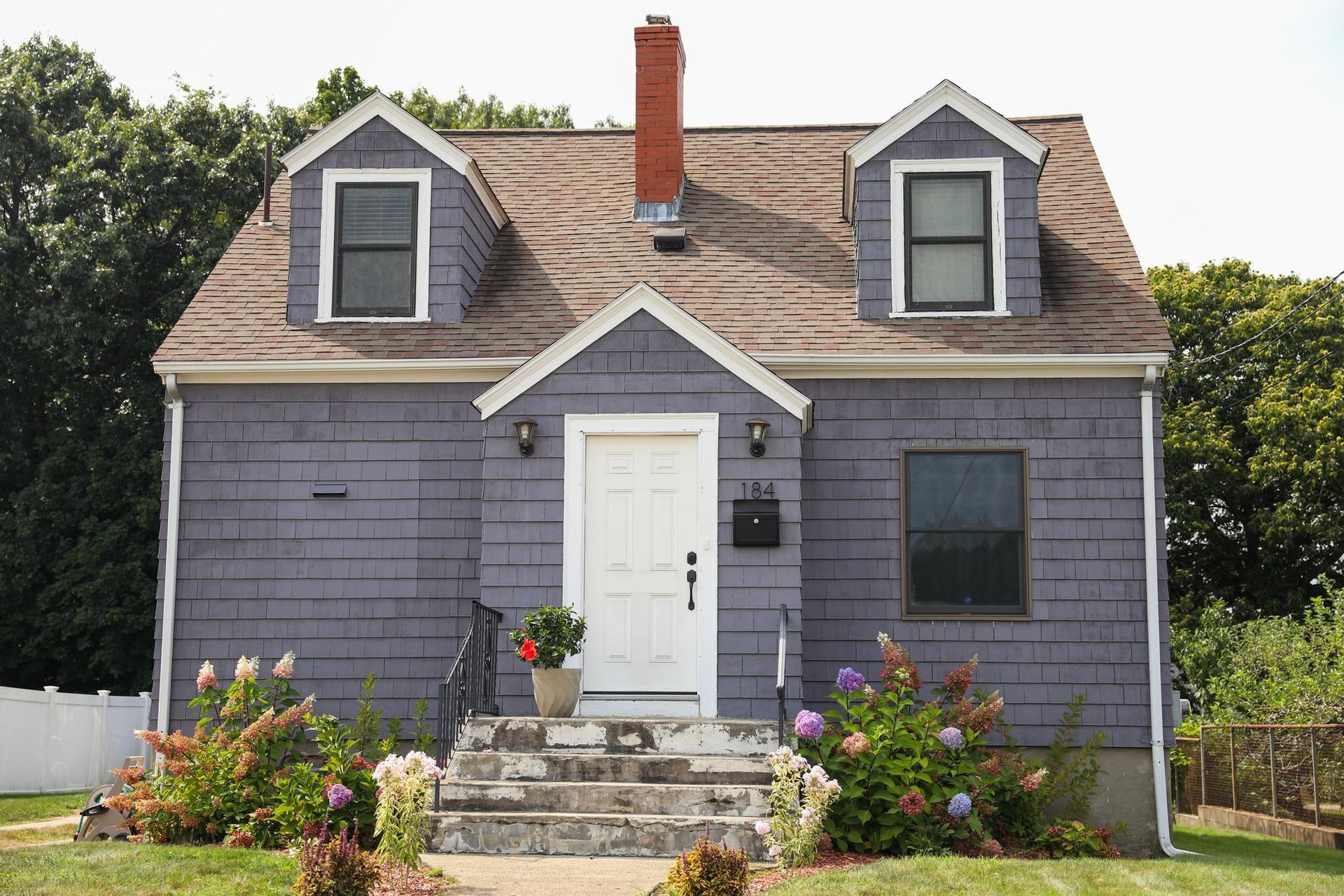 A purple house with a chimney on the roof